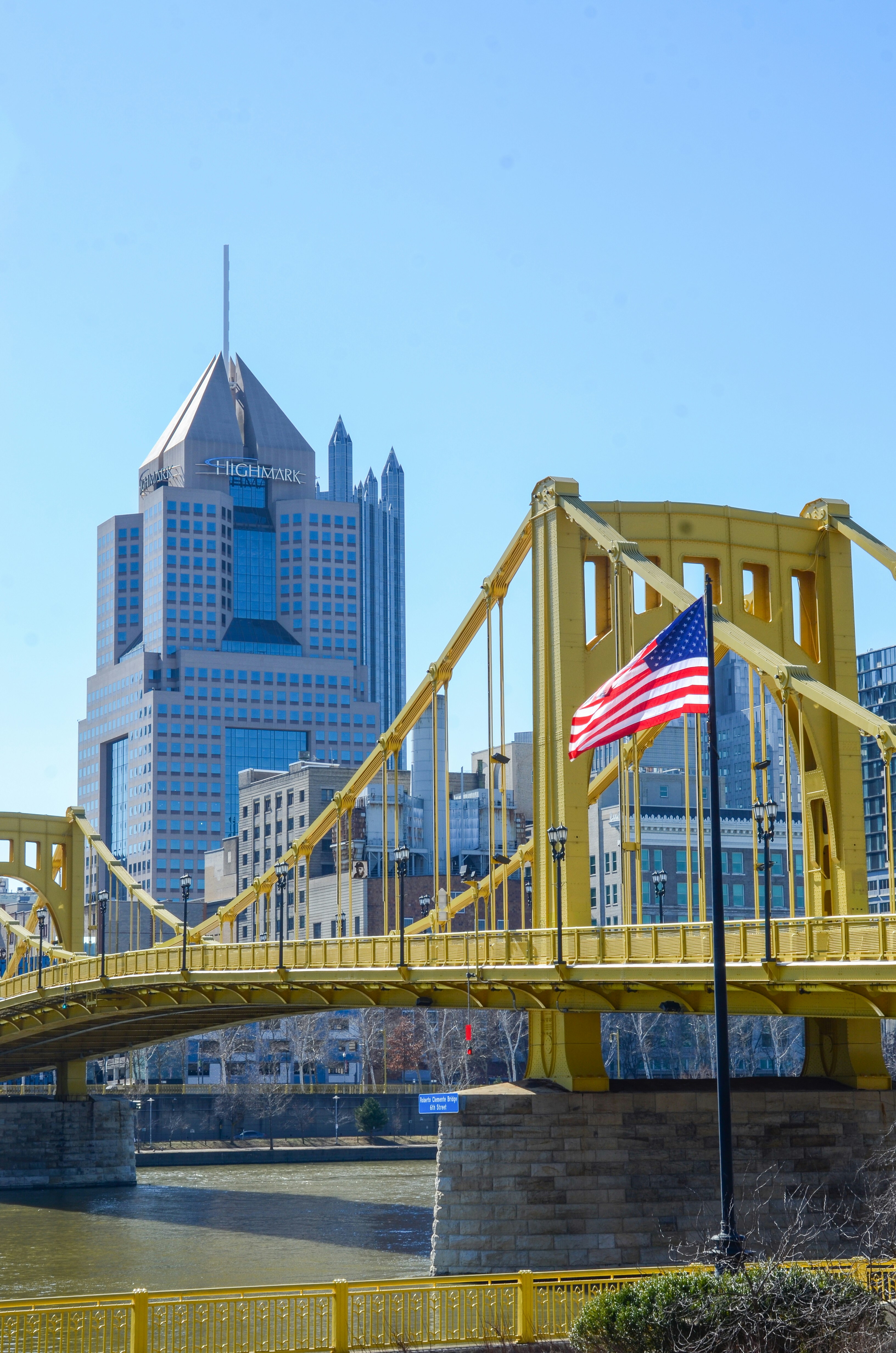 アメリカ国旗と都市のスカイラインが描かれた黄色い橋