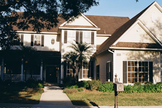 A large, two-story house with a covered porch