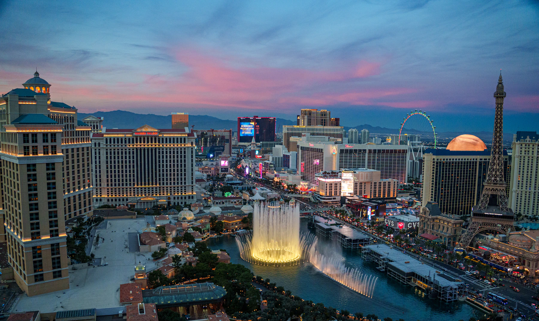 The Las Vegas Strip and Bellagio fountains glowing at twilight
