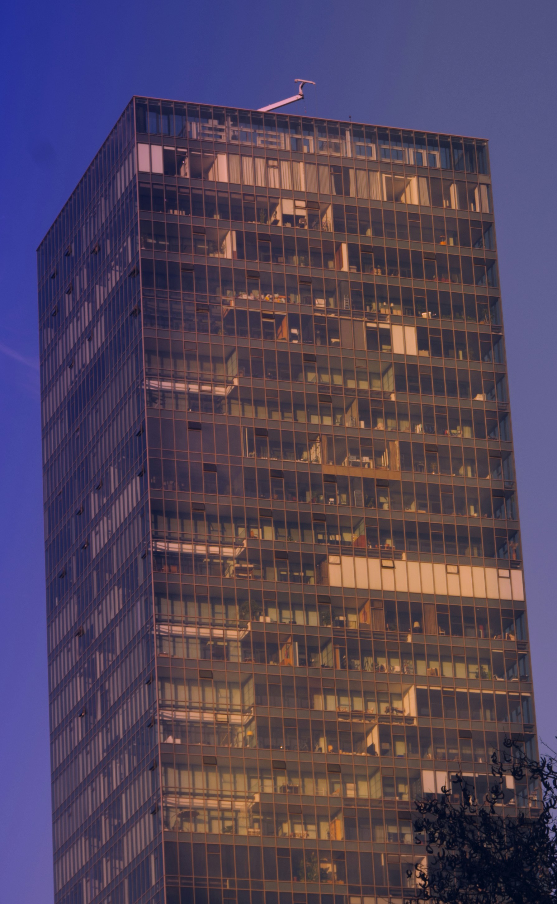 Grattacielo di vetro moderno contro un cielo azzurro.