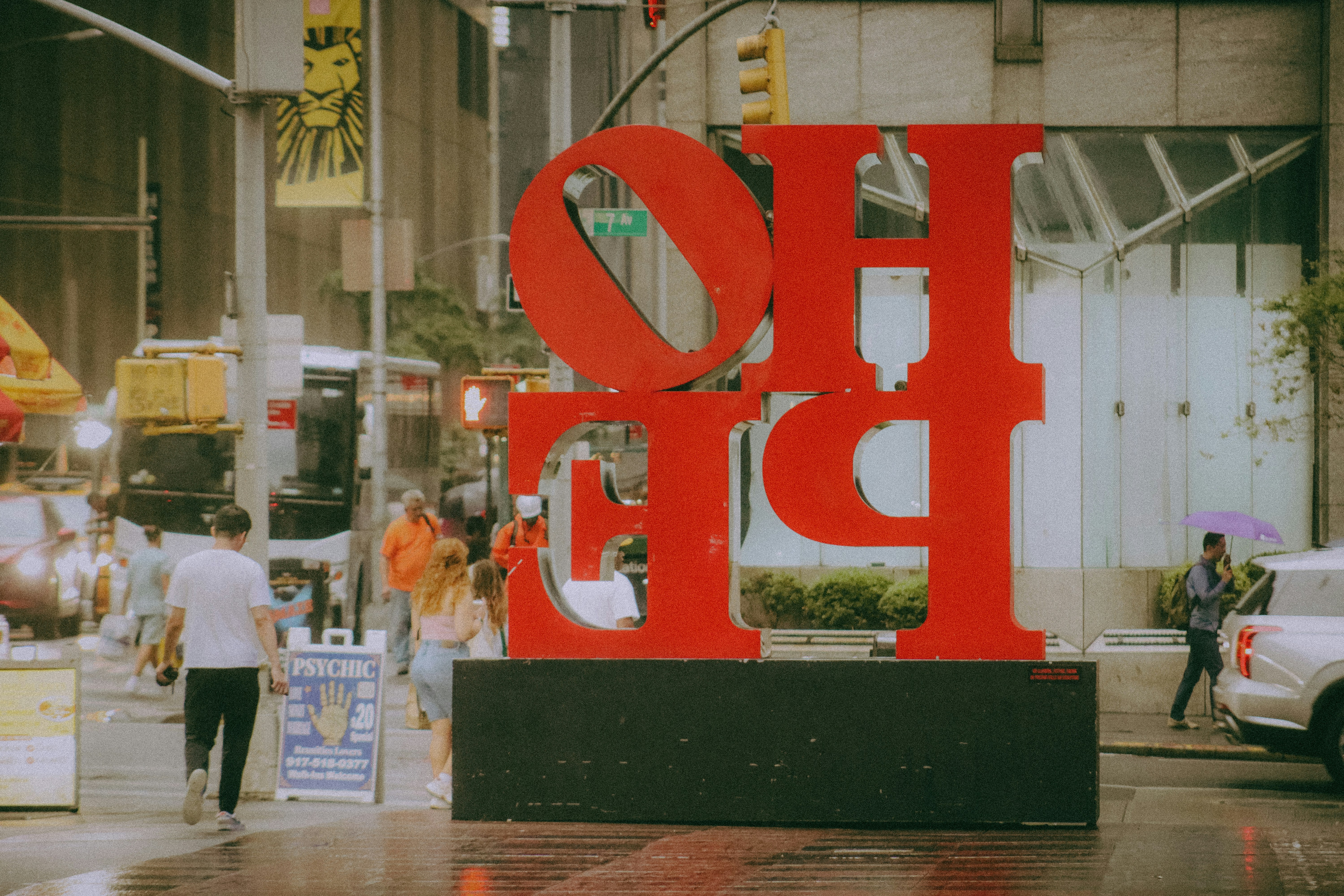 Large red love sculpture on a city street