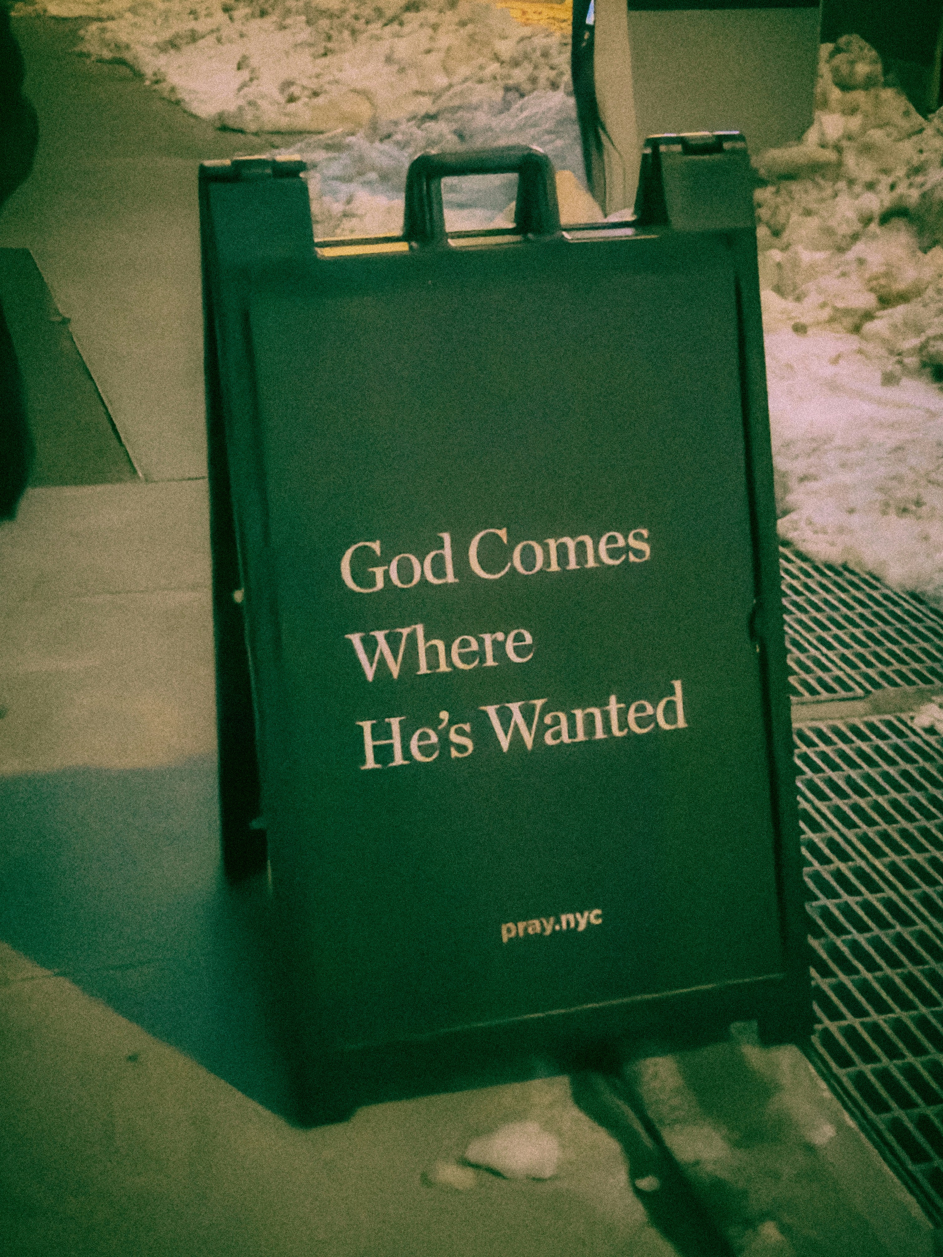 A sign reads "god comes where he's wanted"