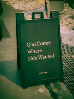 A sign reads "god comes where he's wanted"