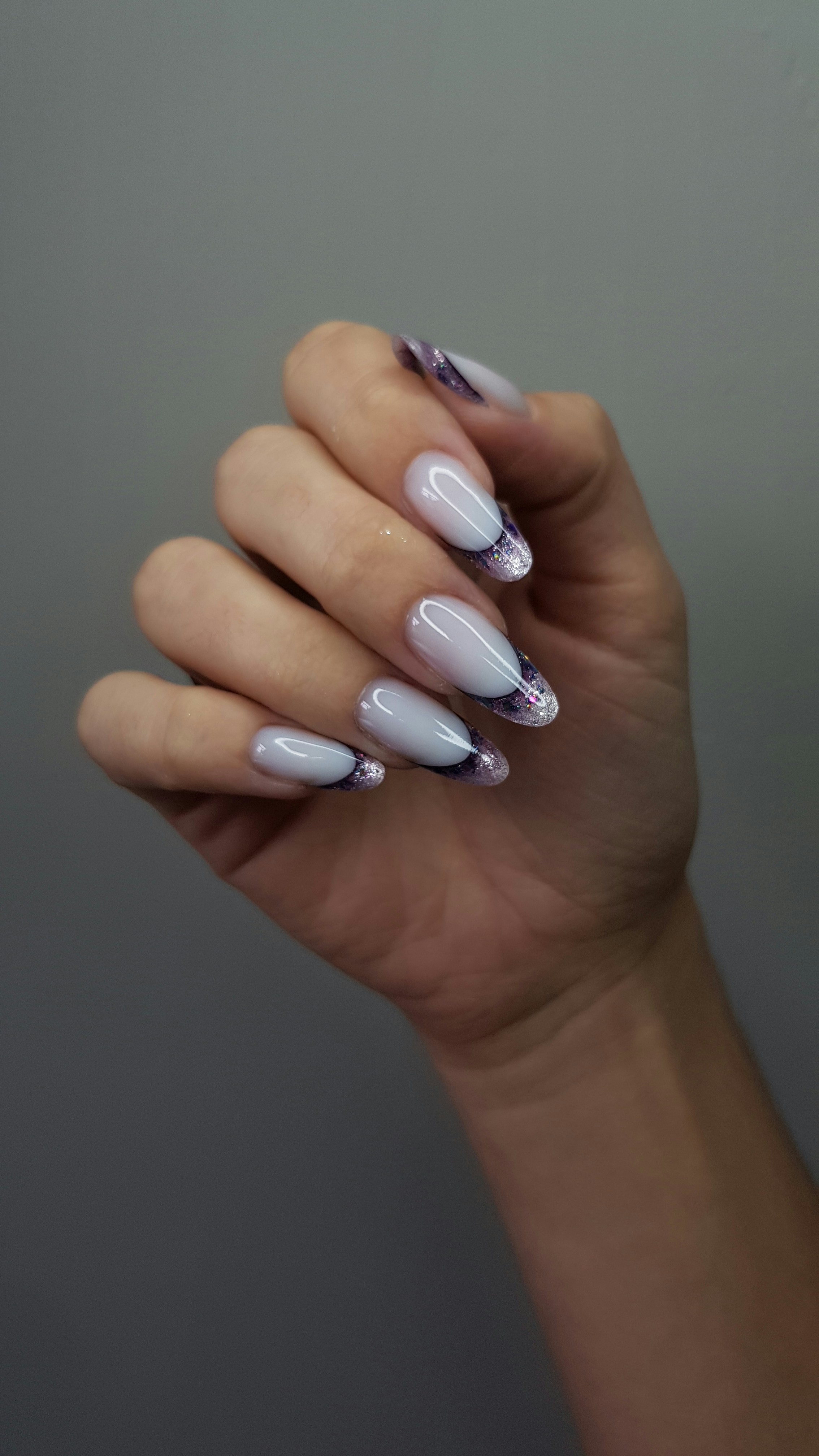 Elegant white nails with purple and black marbled tips.