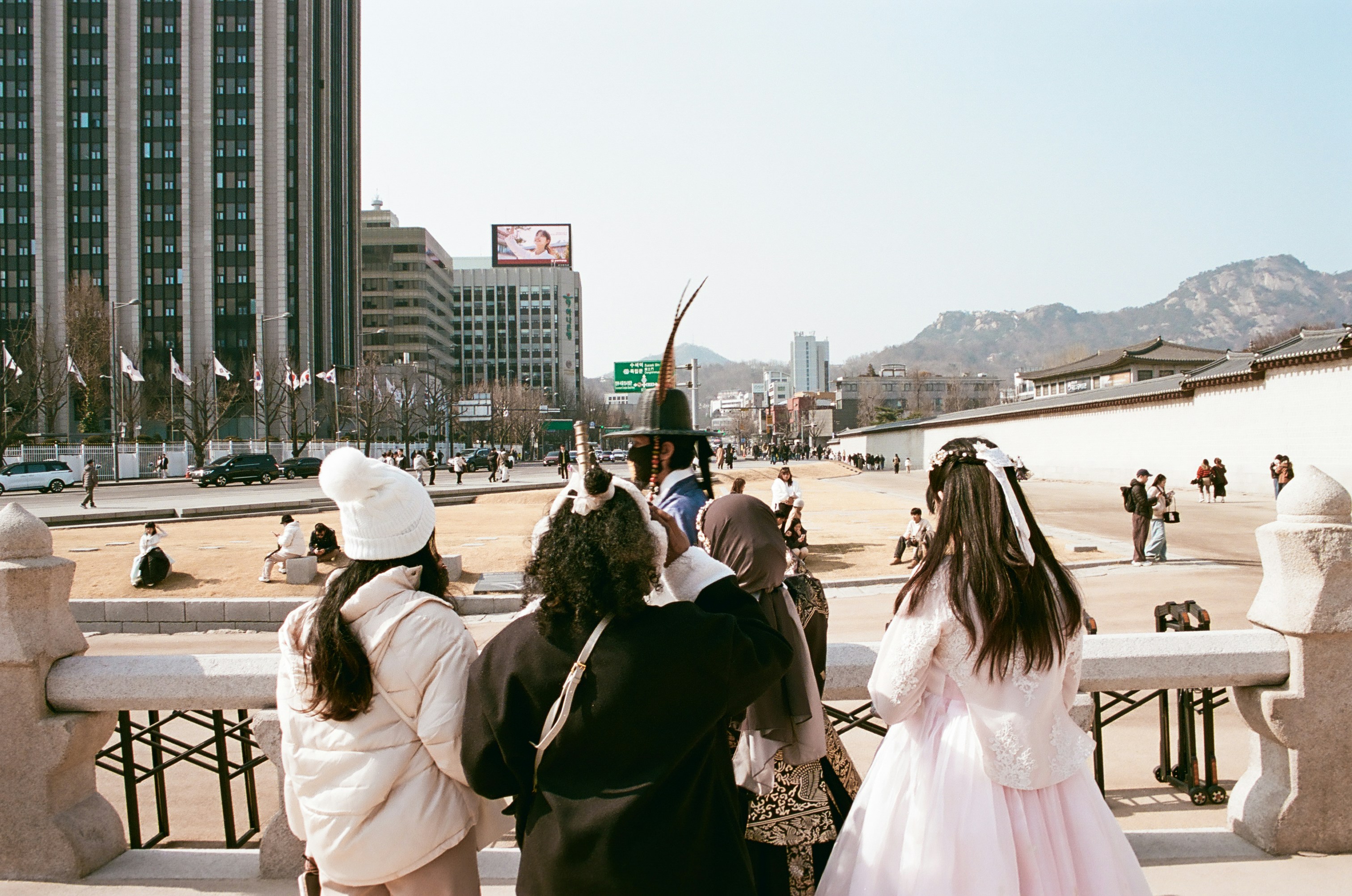 People in traditional korean clothing at a historical site.