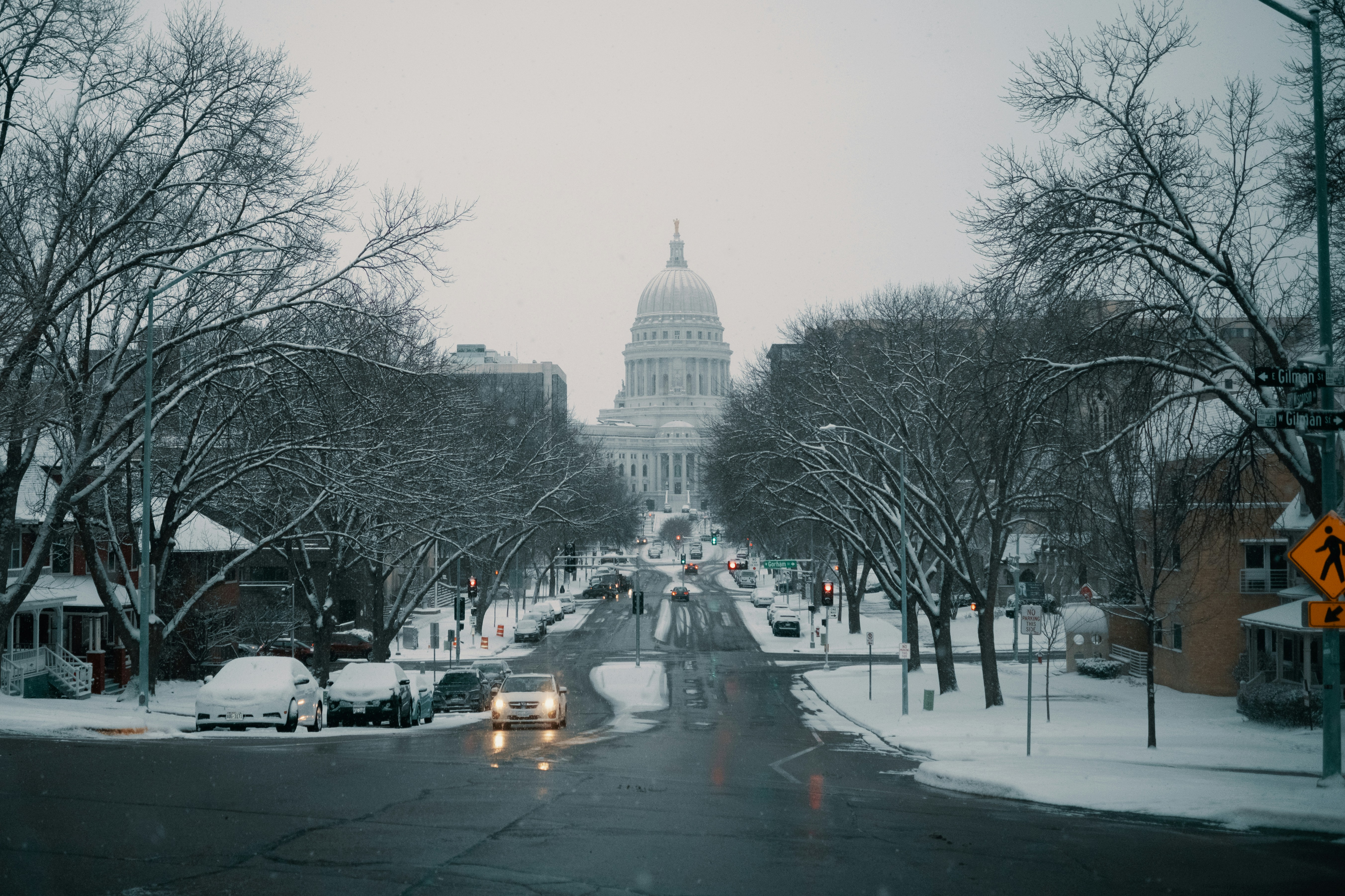 Snowy street leading to a domed building