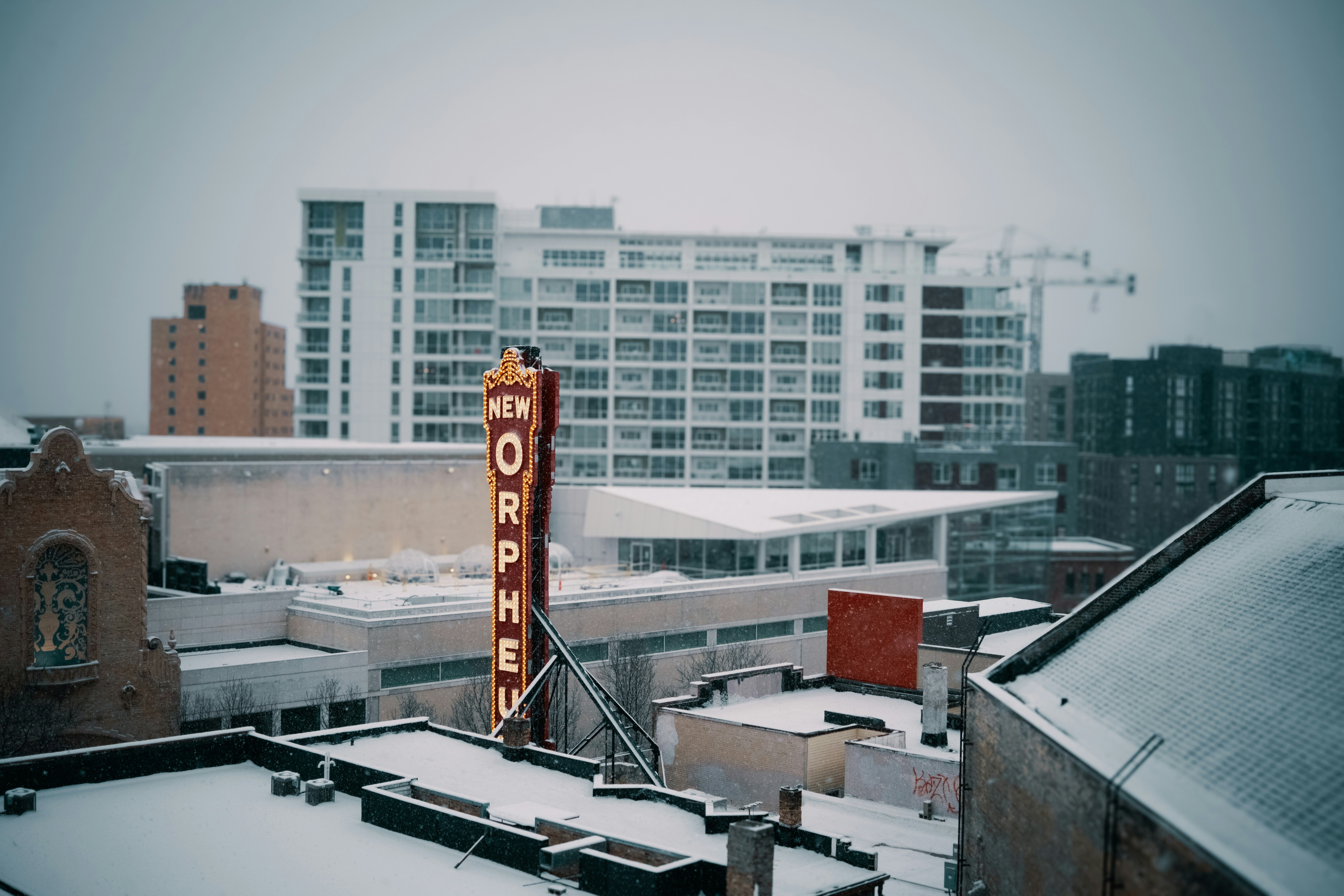 Snowy cityscape with a vintage marquee sign