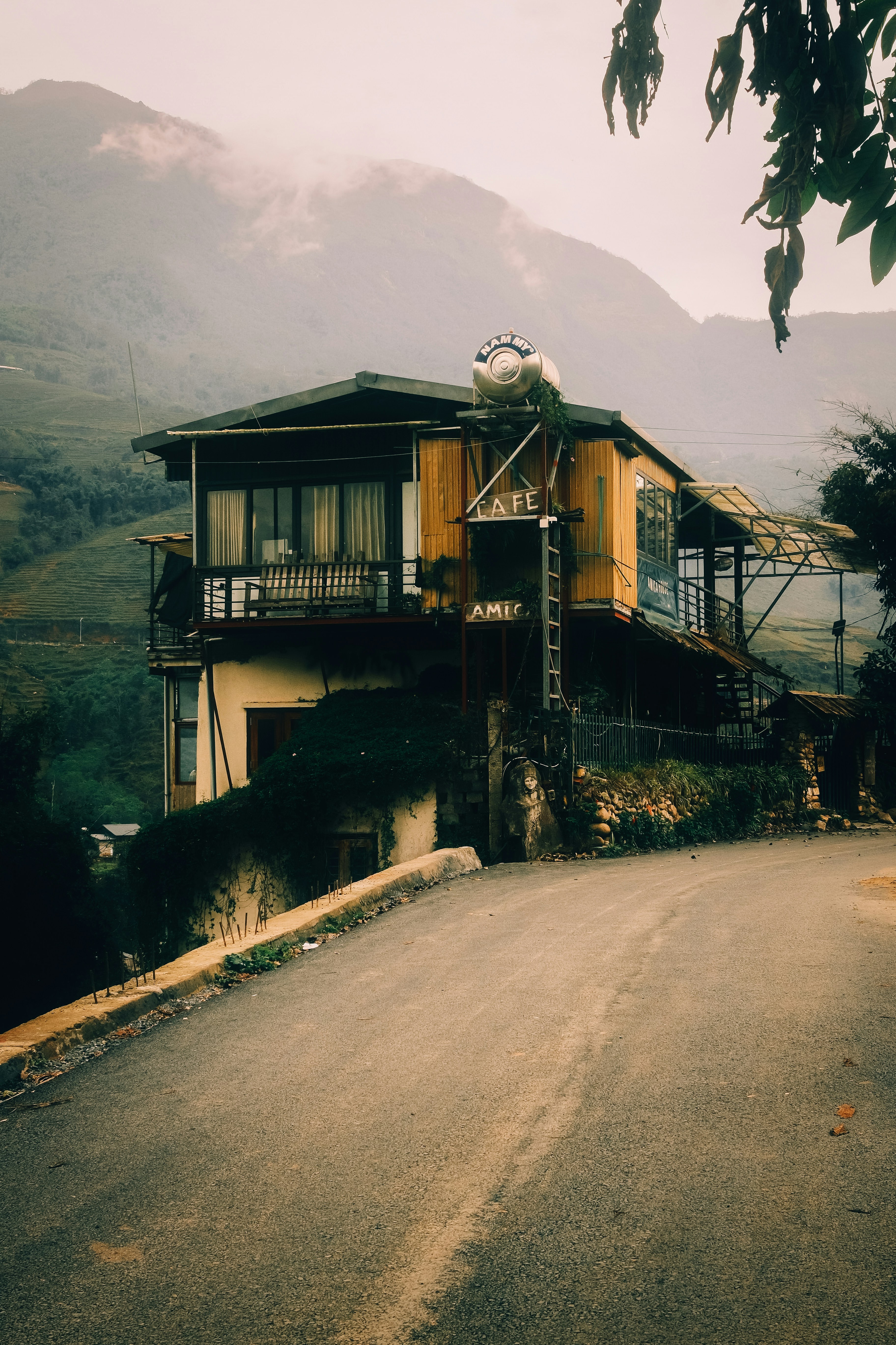 A rustic cafe building on a hillside road