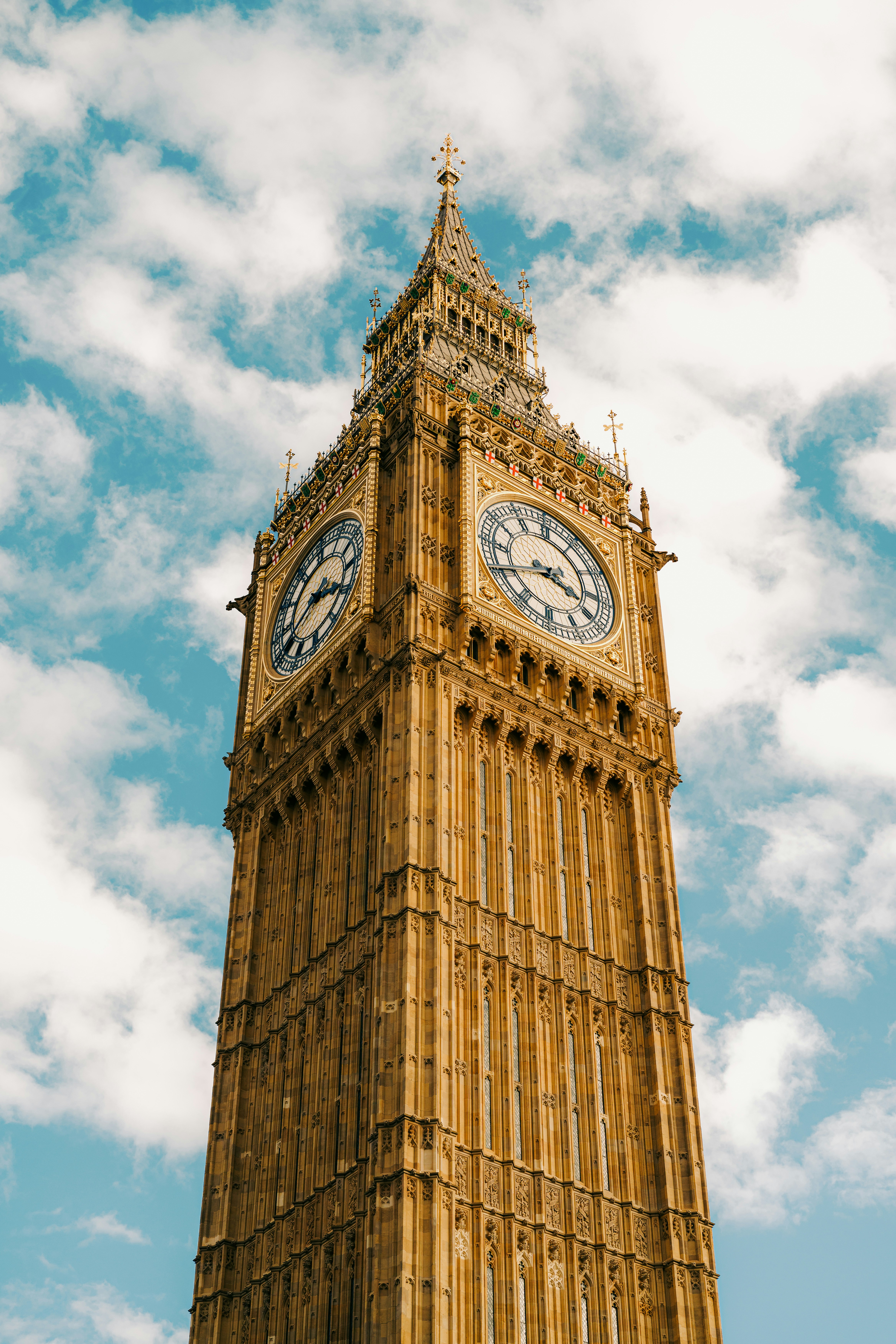 Big ben clock tower against a cloudy blue sky