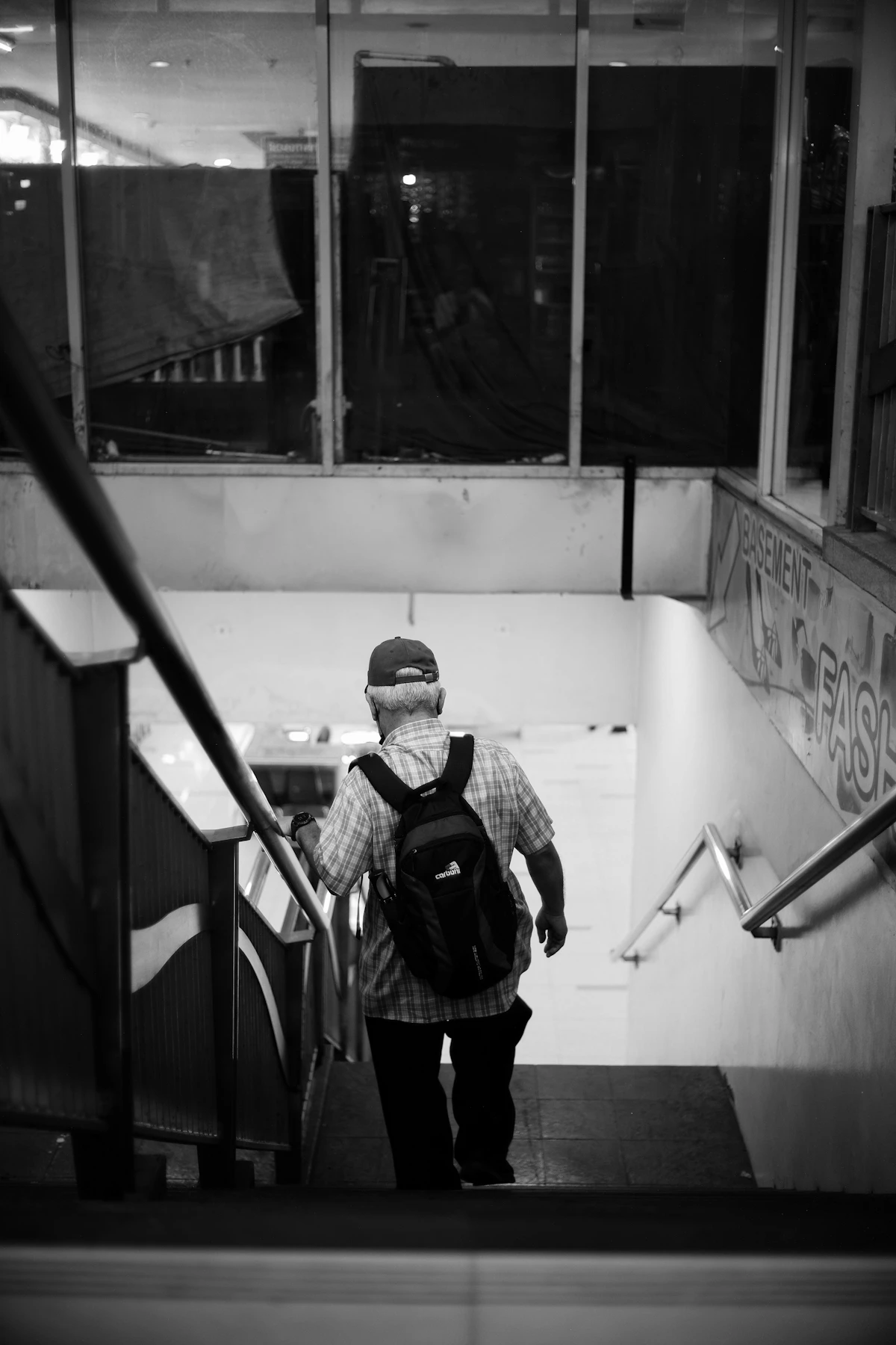 An older adult walking on a staircase