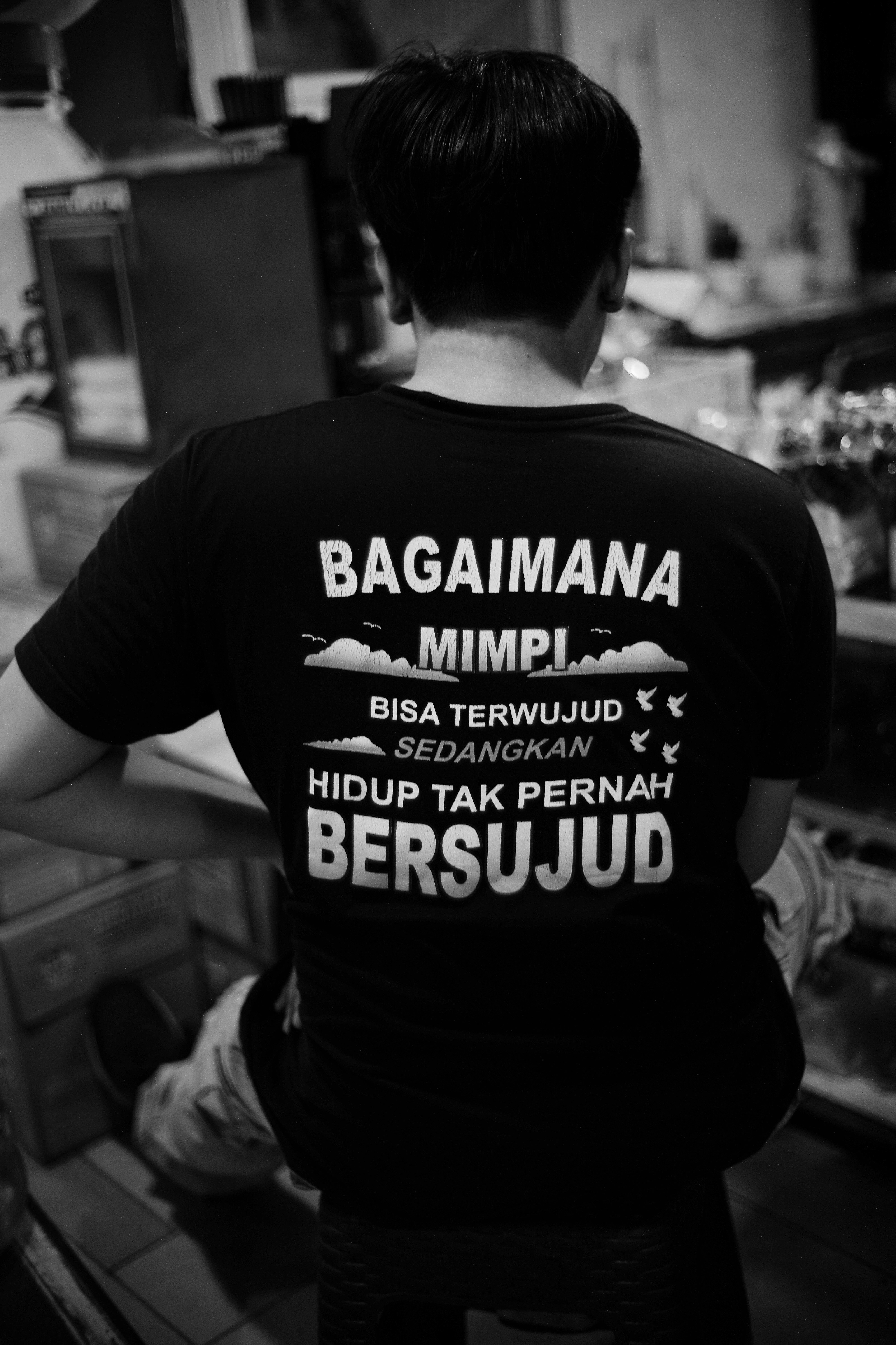 Man in black t-shirt with text graphic