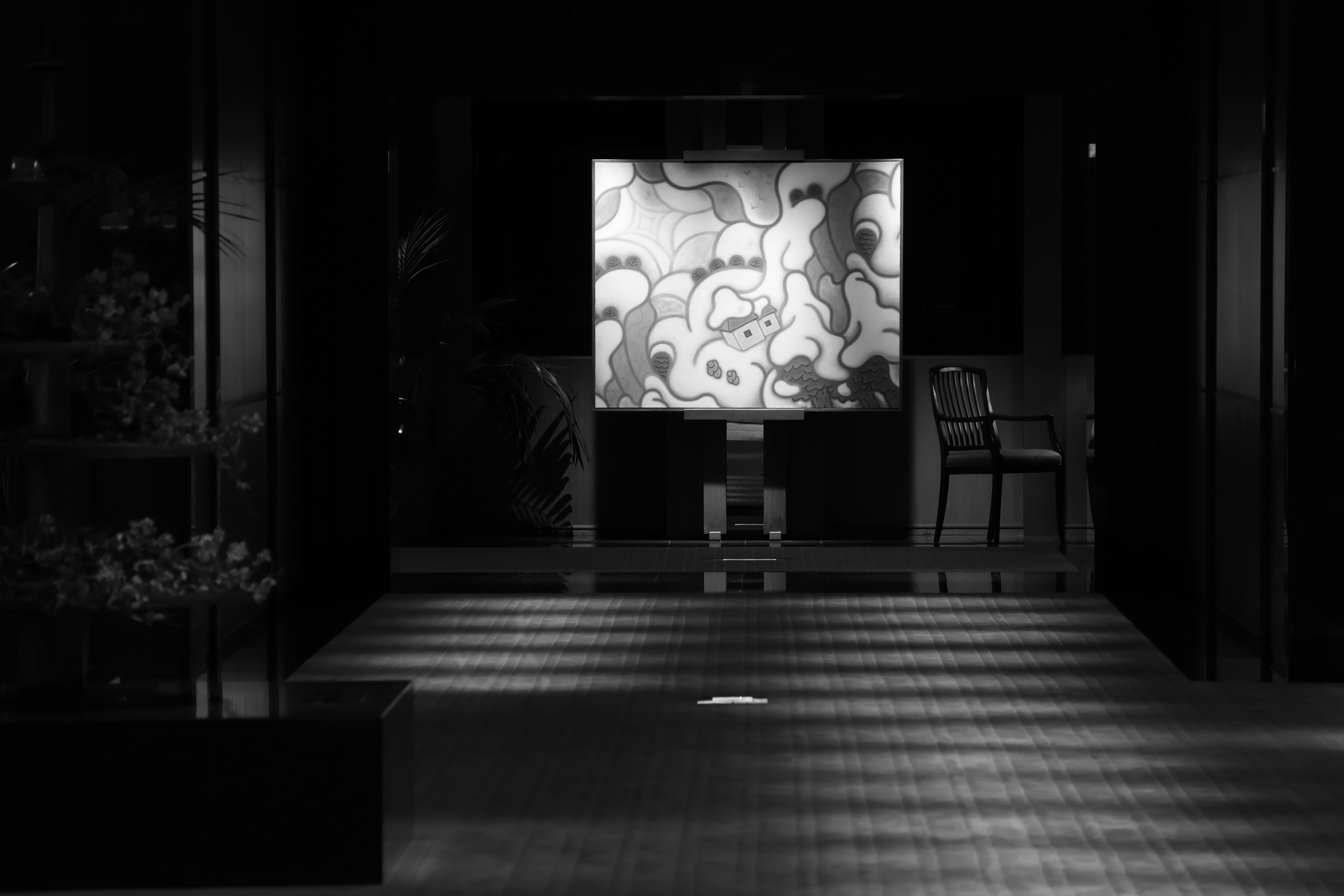 Abstract art displayed in a dimly lit room