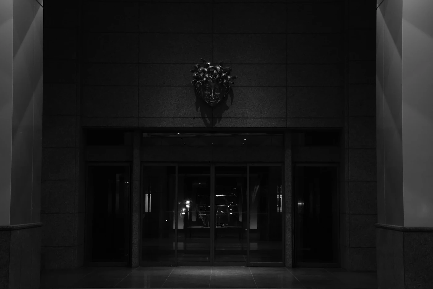 A hotel entrance at night.