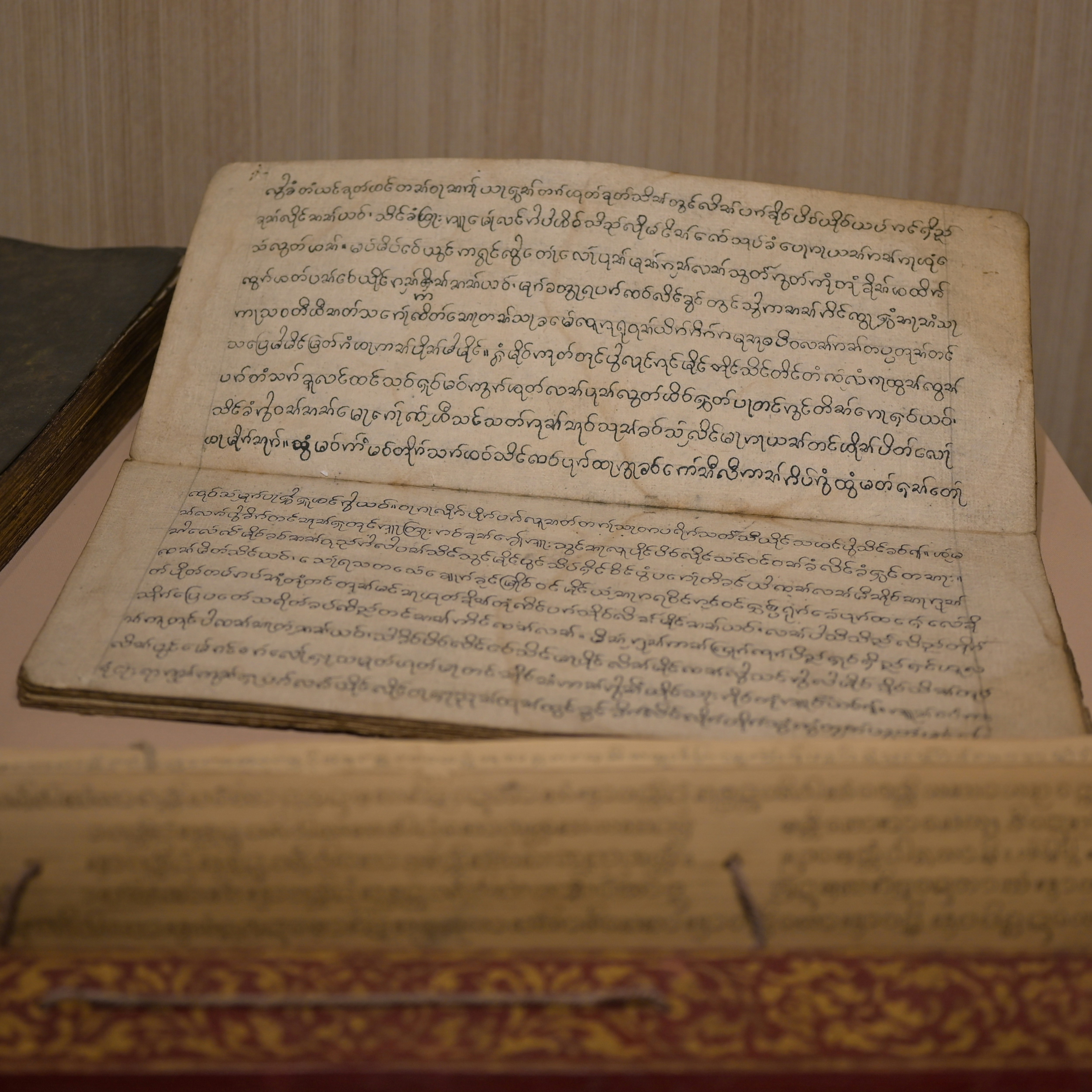 An open ancient manuscript with handwritten text.