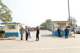 Guards stand at the entrance of a facility.