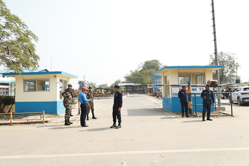 Guards stand at the entrance of a facility