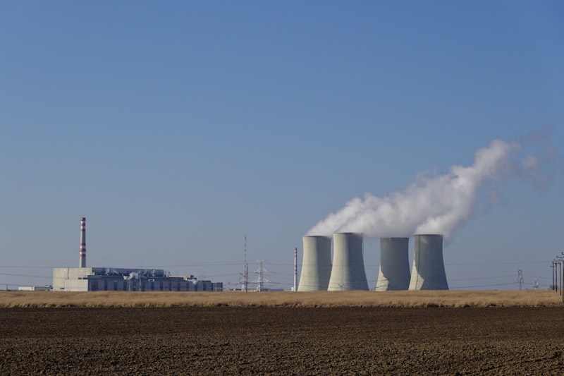 Industrial power plant with cooling towers emitting steam
