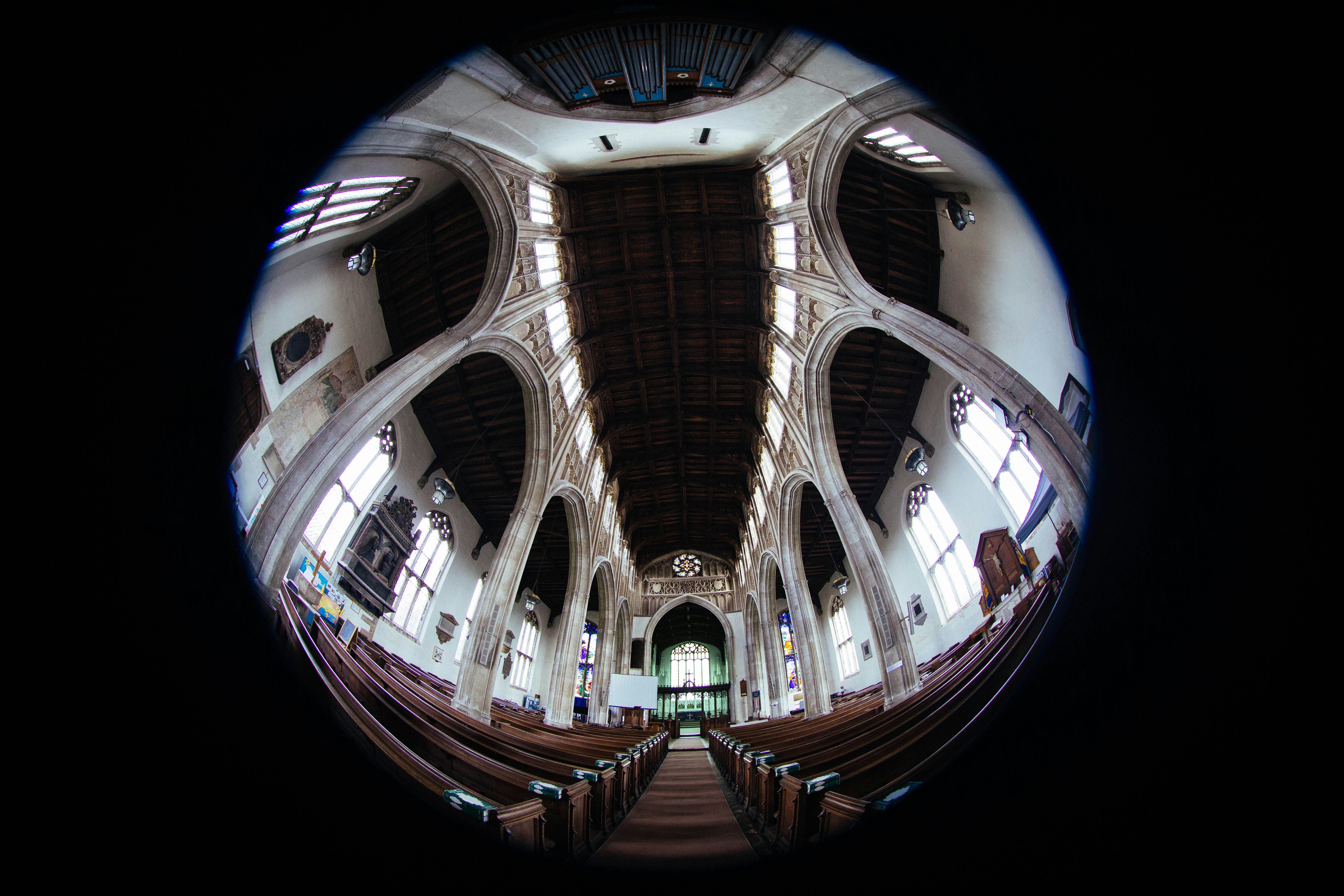 Intérieur d’une grande église avec des bancs et un plafond voûté