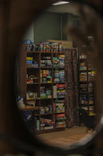 Shelves filled with board games in a room.