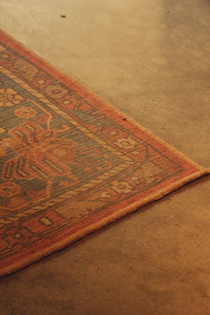 Close-up of a patterned rug on a concrete floor
