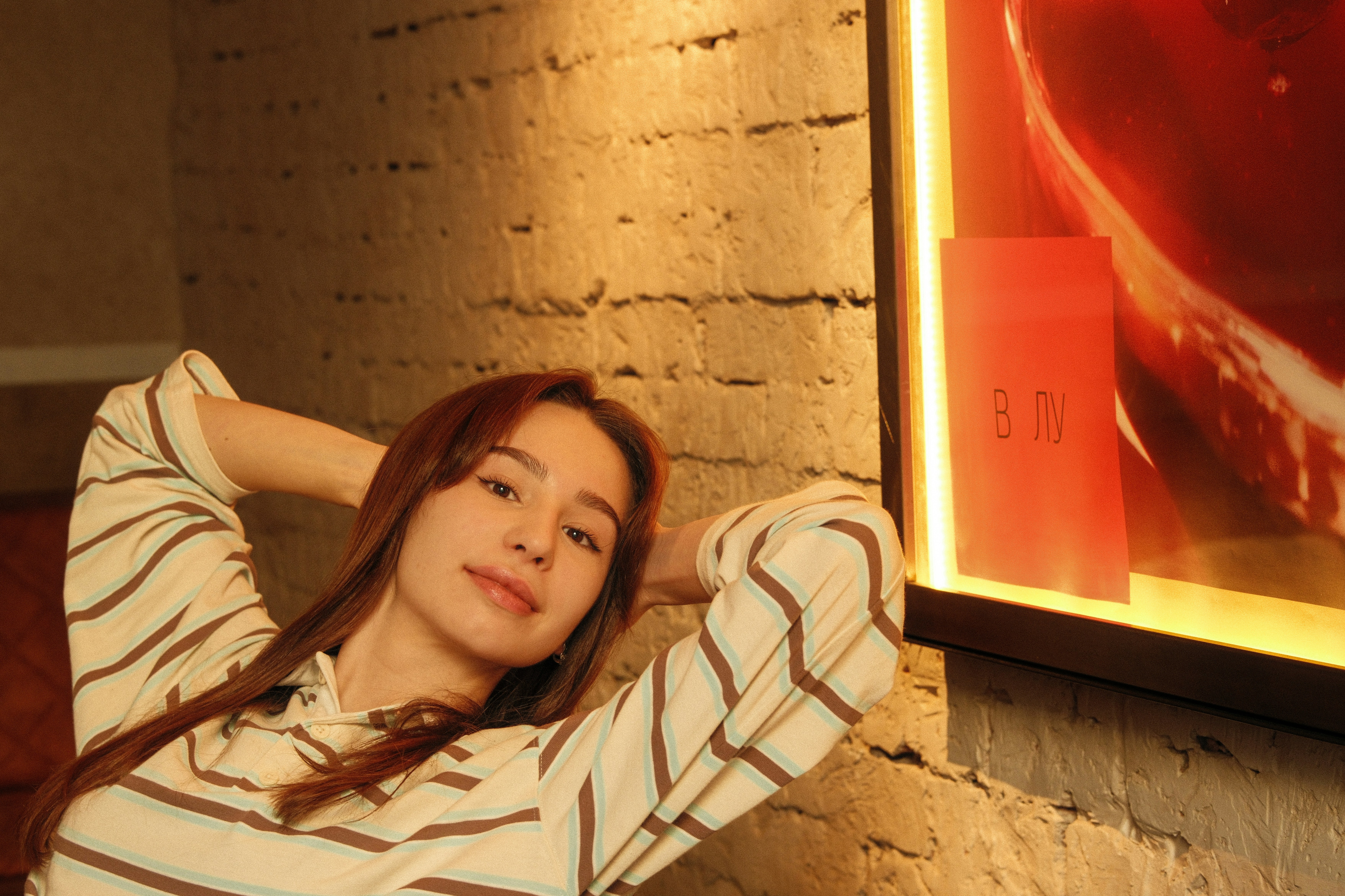 Young woman relaxing with hands behind head