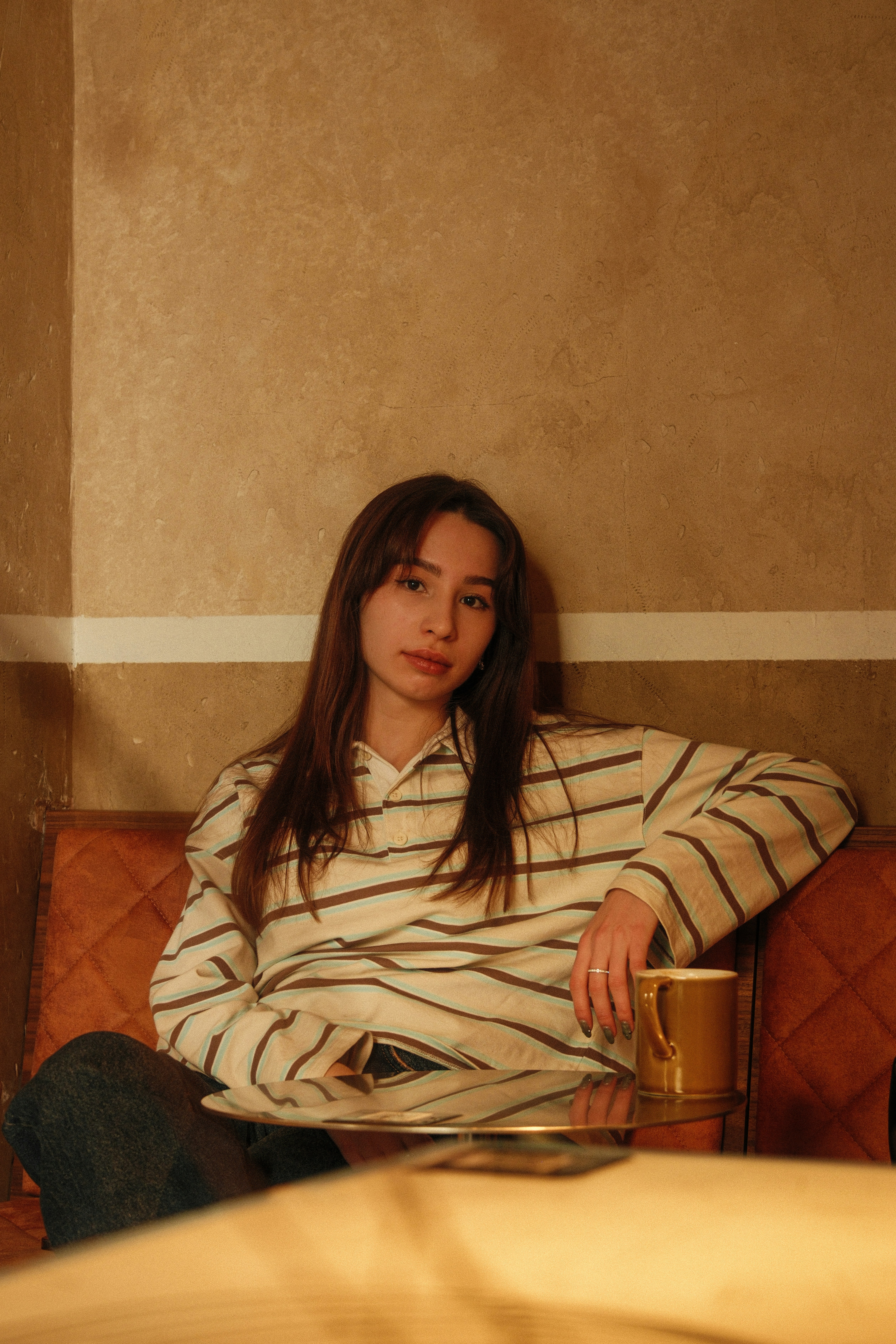 Young woman sitting with a mug on a table