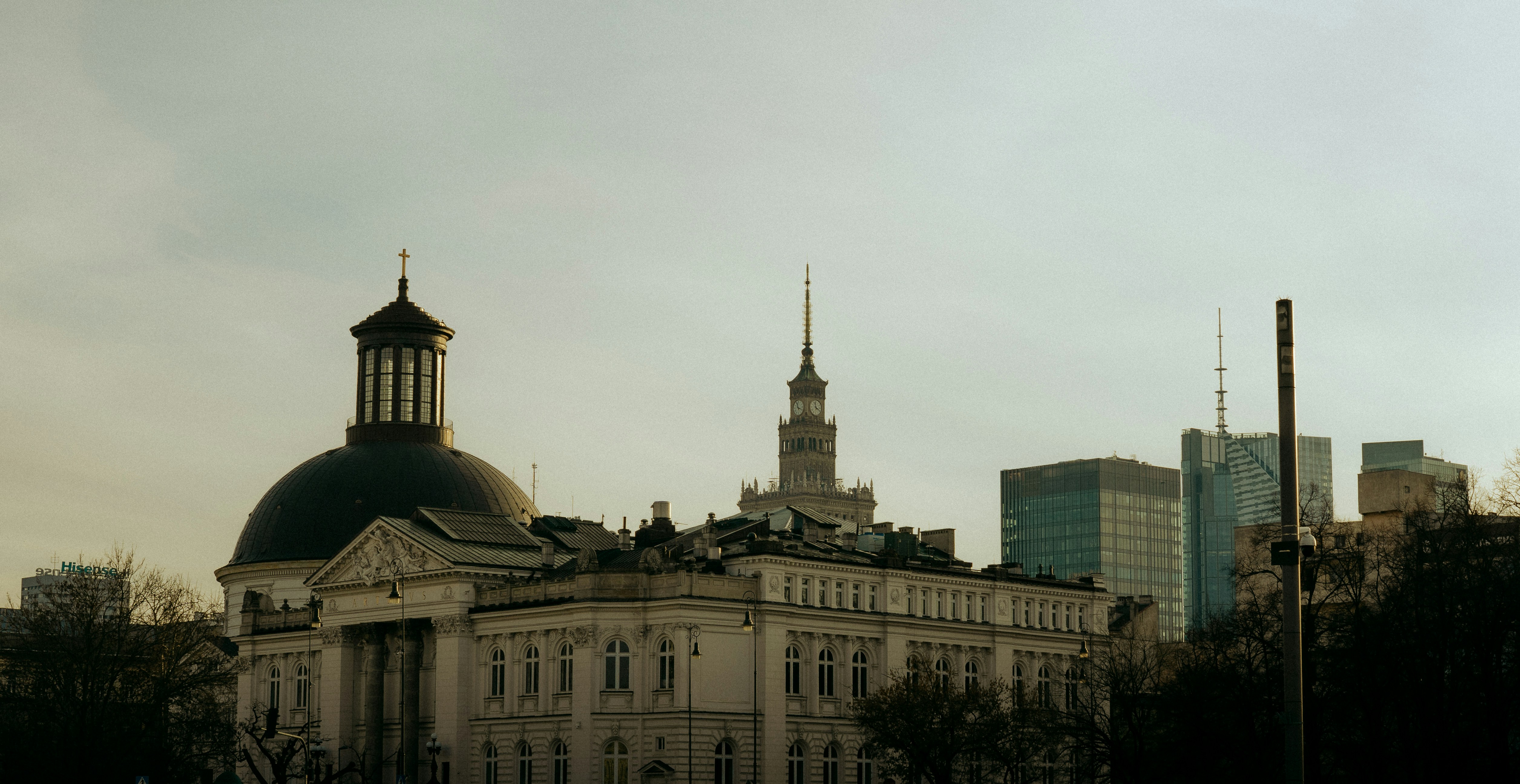 Historic building with modern skyscrapers in background.