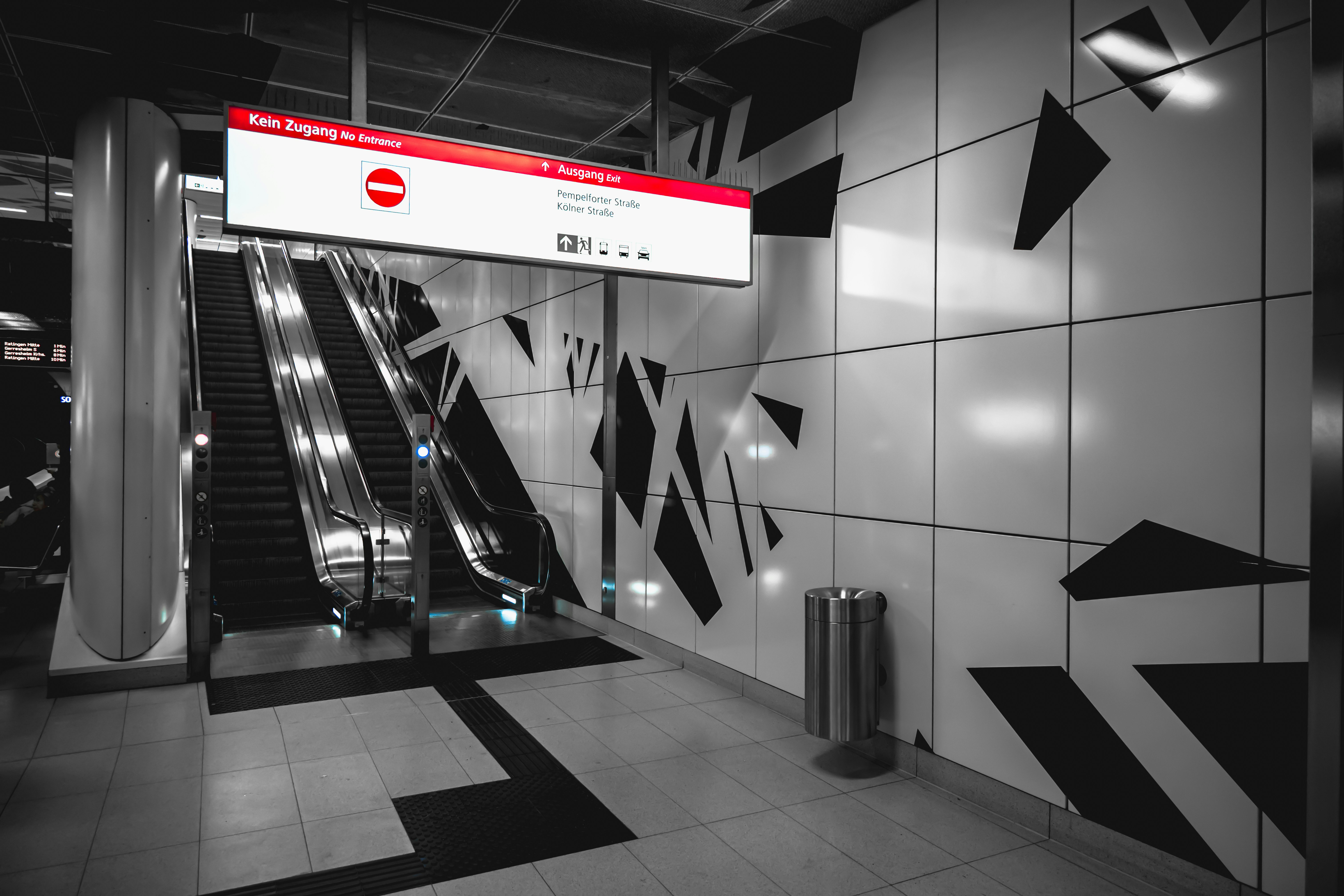 Station de métro moderne avec escalators et œuvres murales abstraites