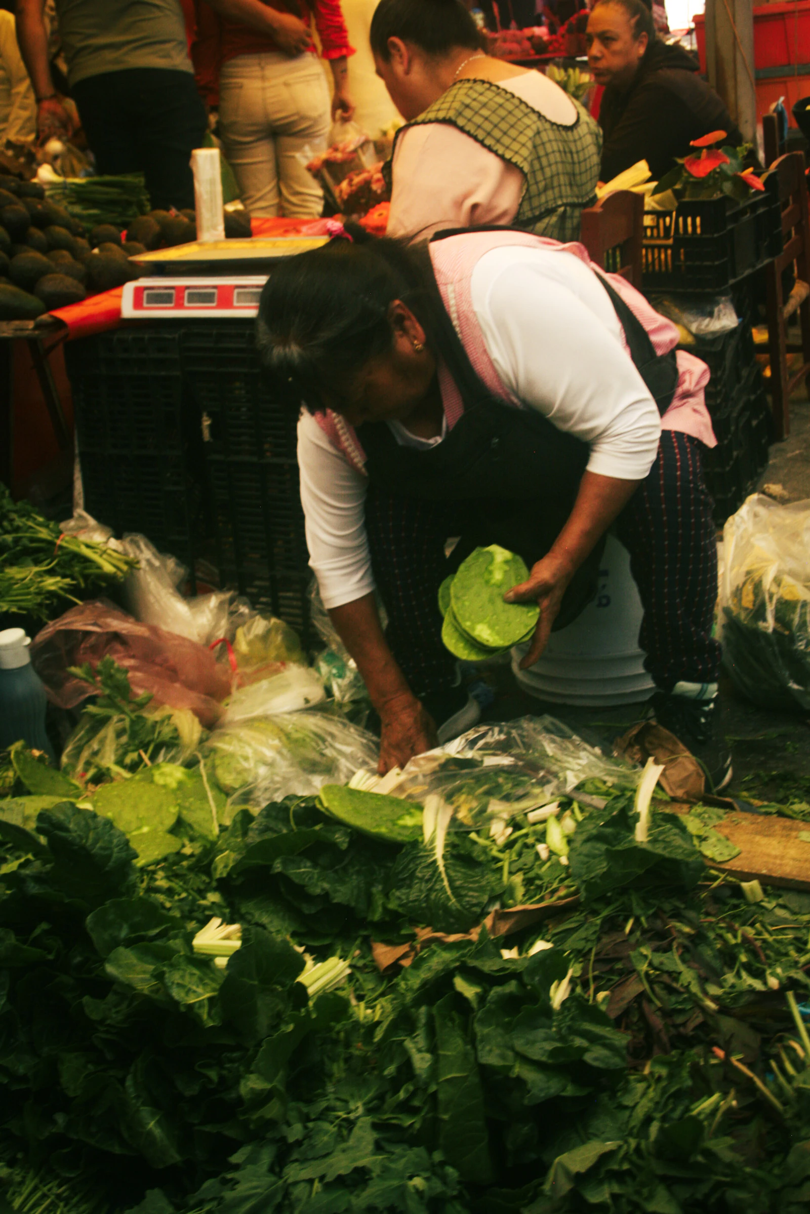 Vendor at a Mexican market displaying fresh produce