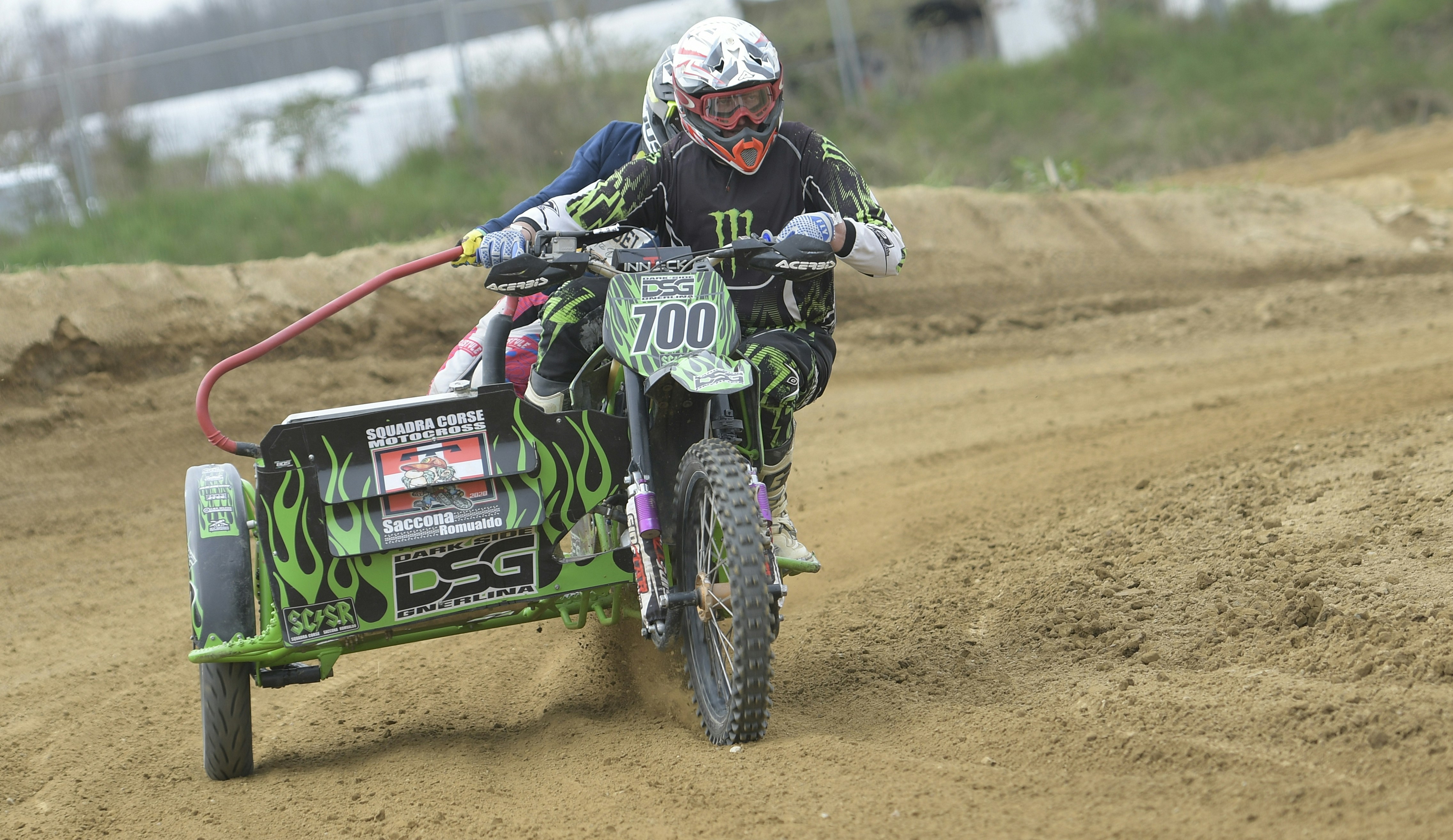 Motocross rider on a dirt track with a sidecar