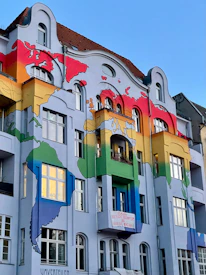 Building facade painted with a rainbow world map