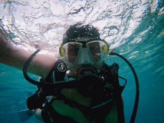 Scuba diver wearing mask and breathing apparatus underwater