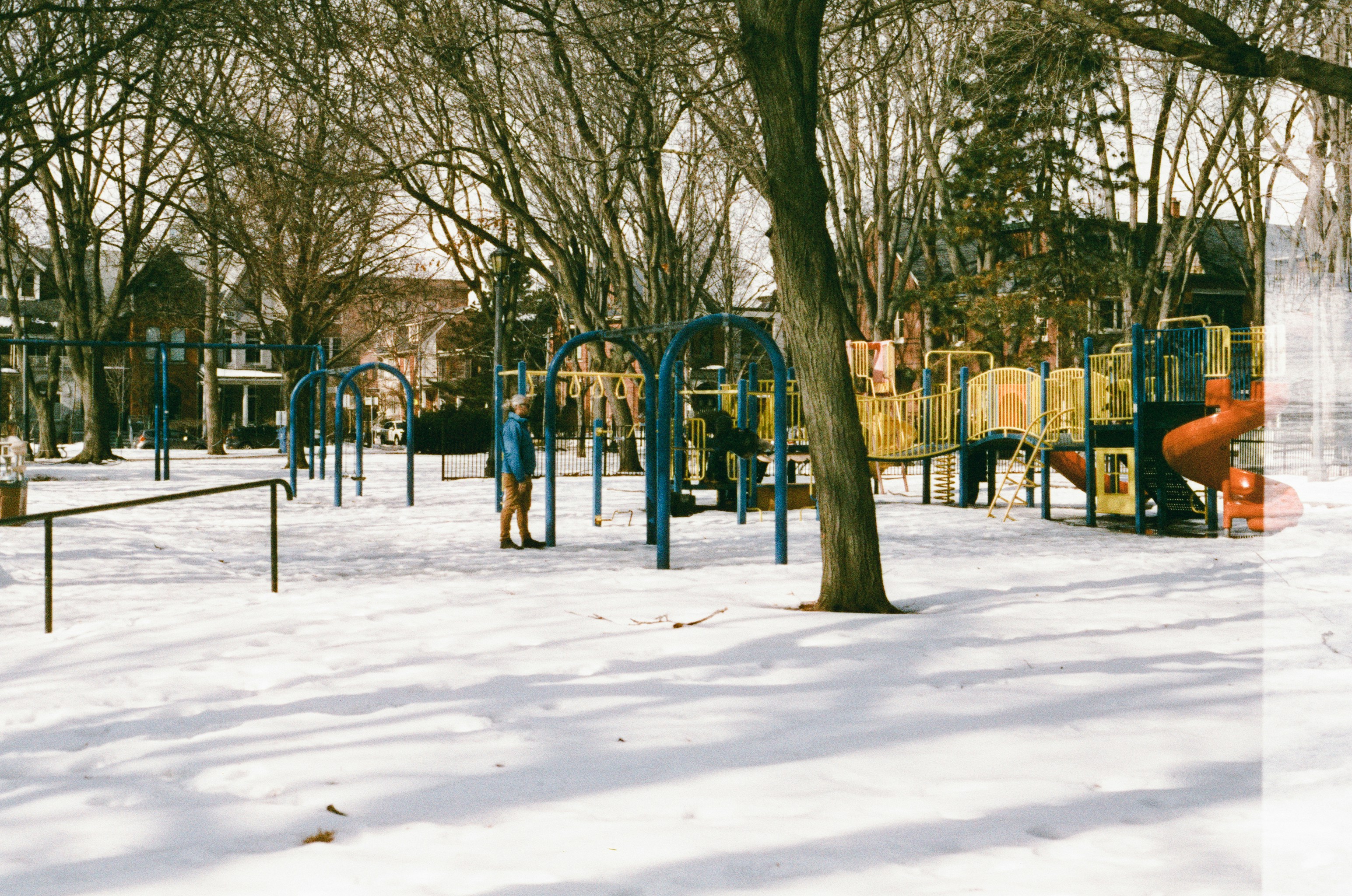 A deserted playground covered in snow