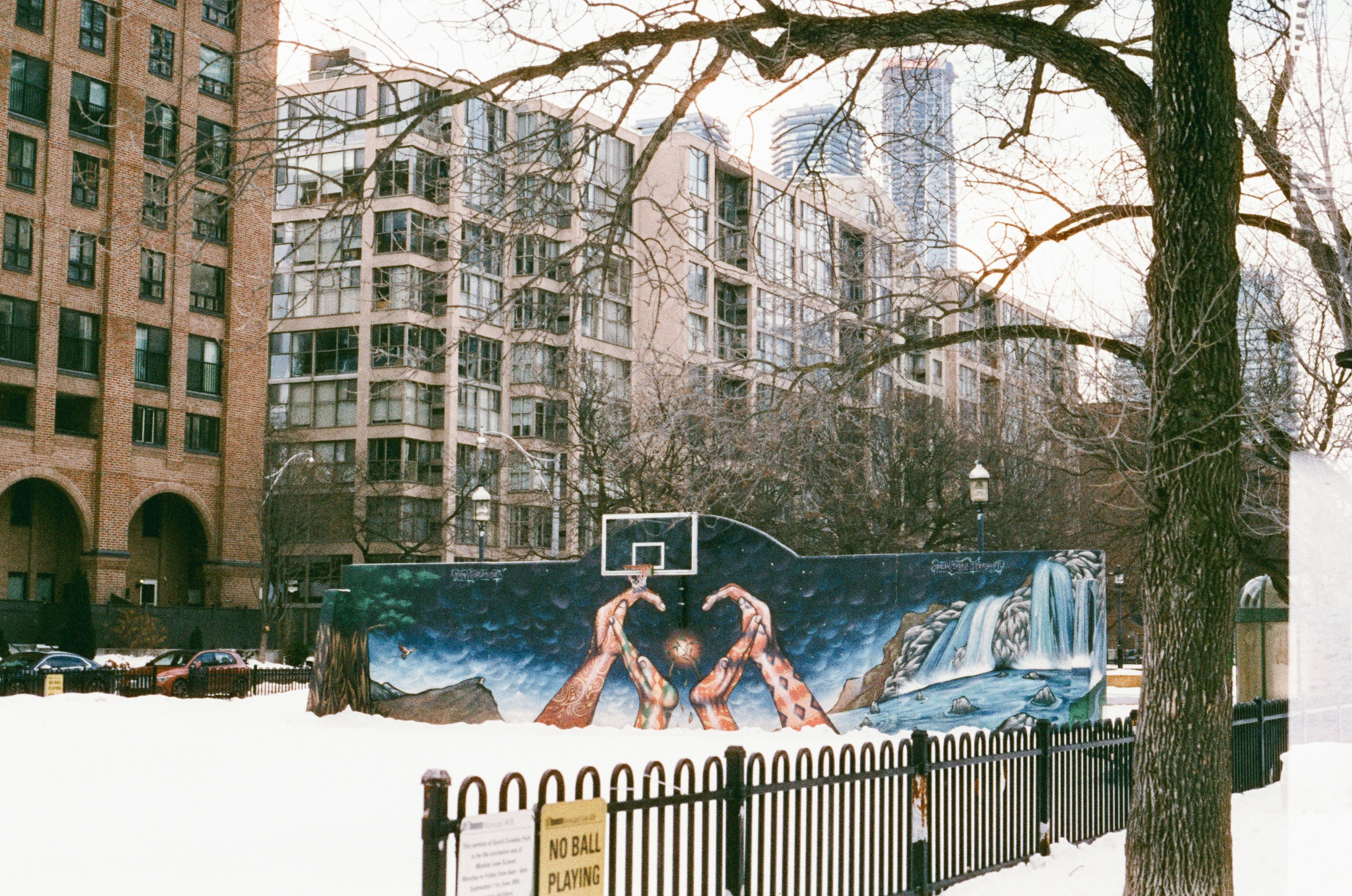 Basketball court mural with snowy surroundings and urban background