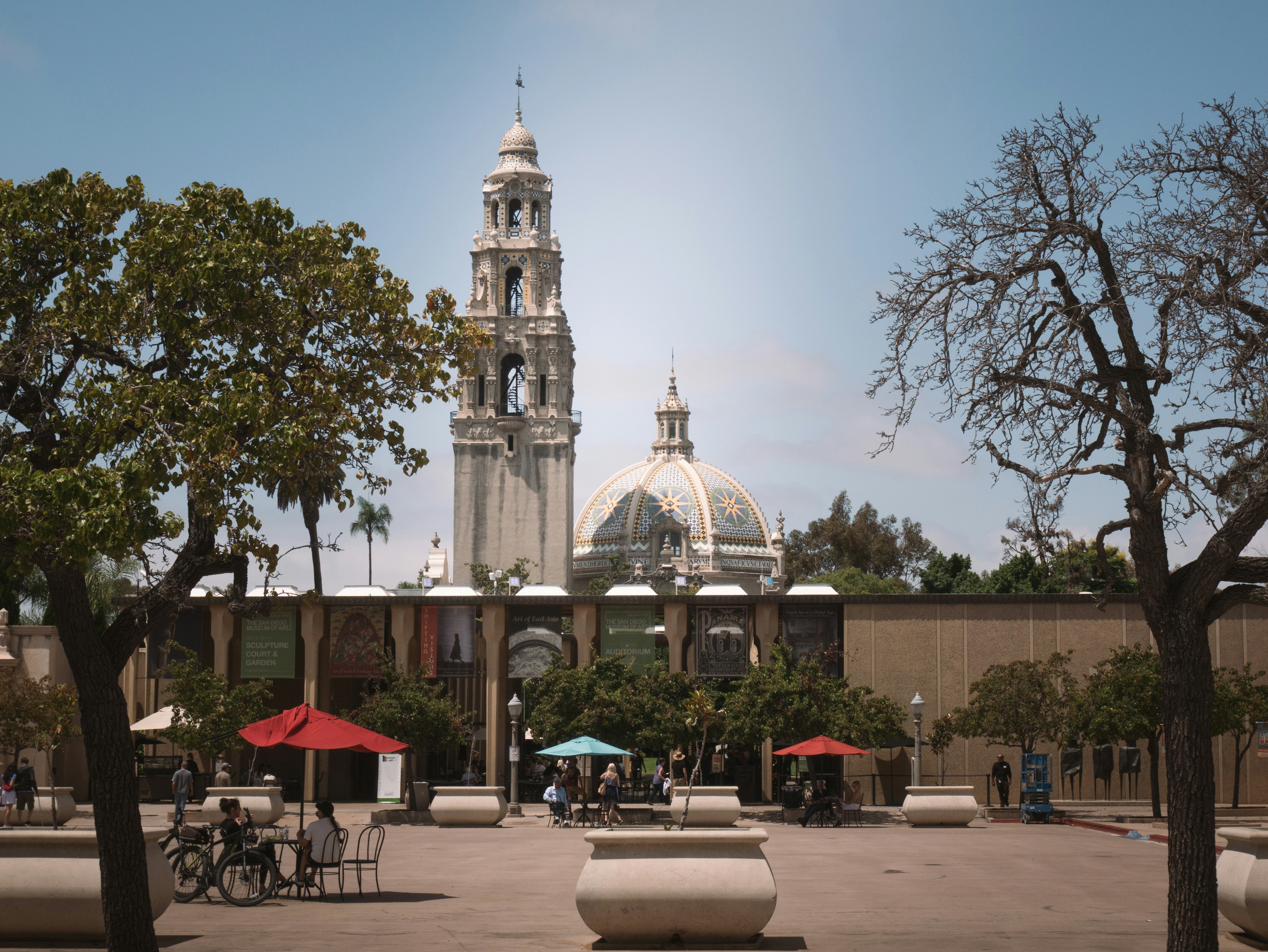 Ornate building with a dome and tower in a plaza.