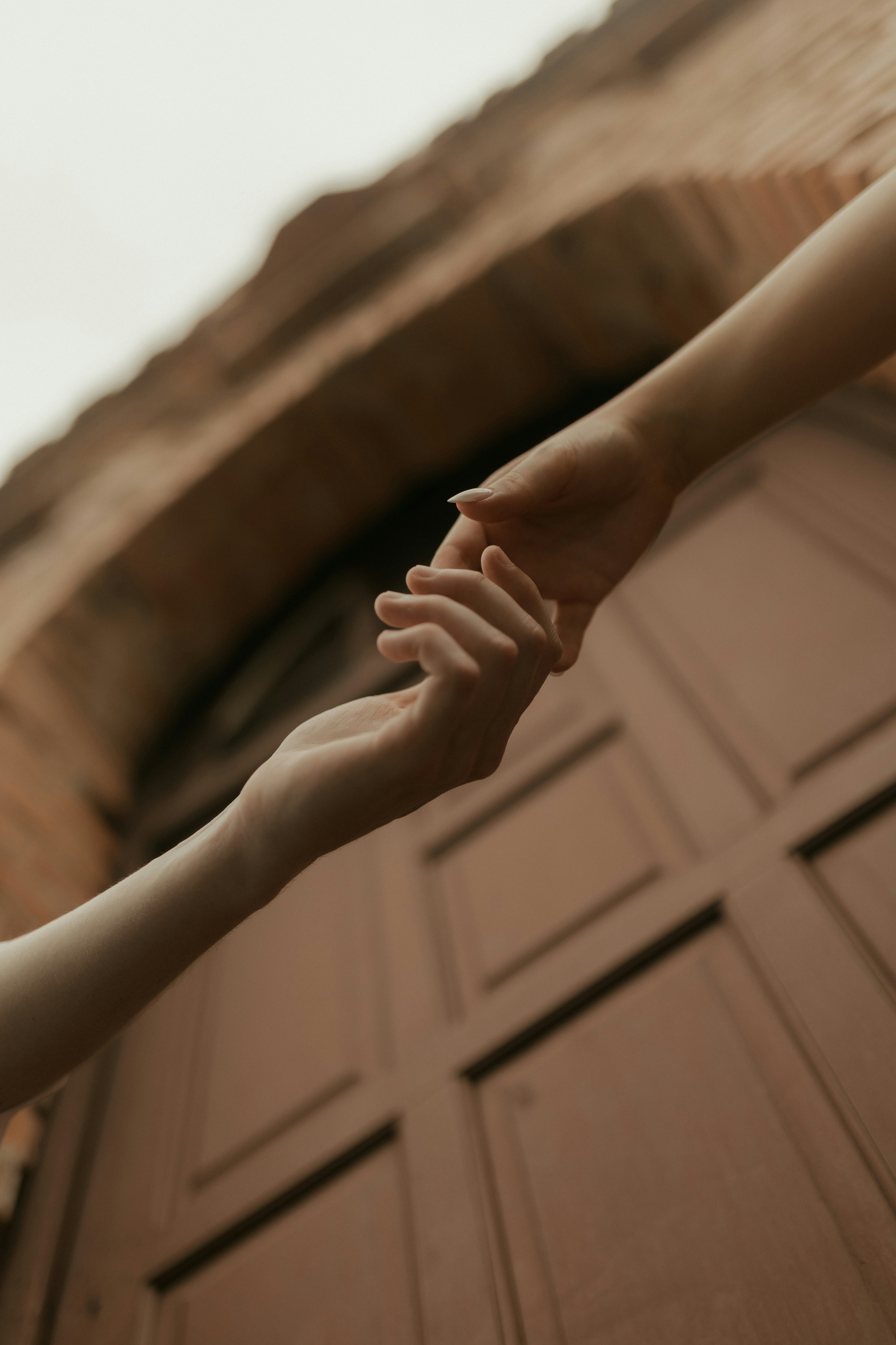 Two hands reaching for each other