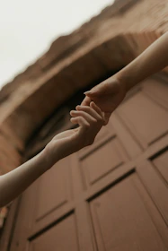 Two hands reaching for each other