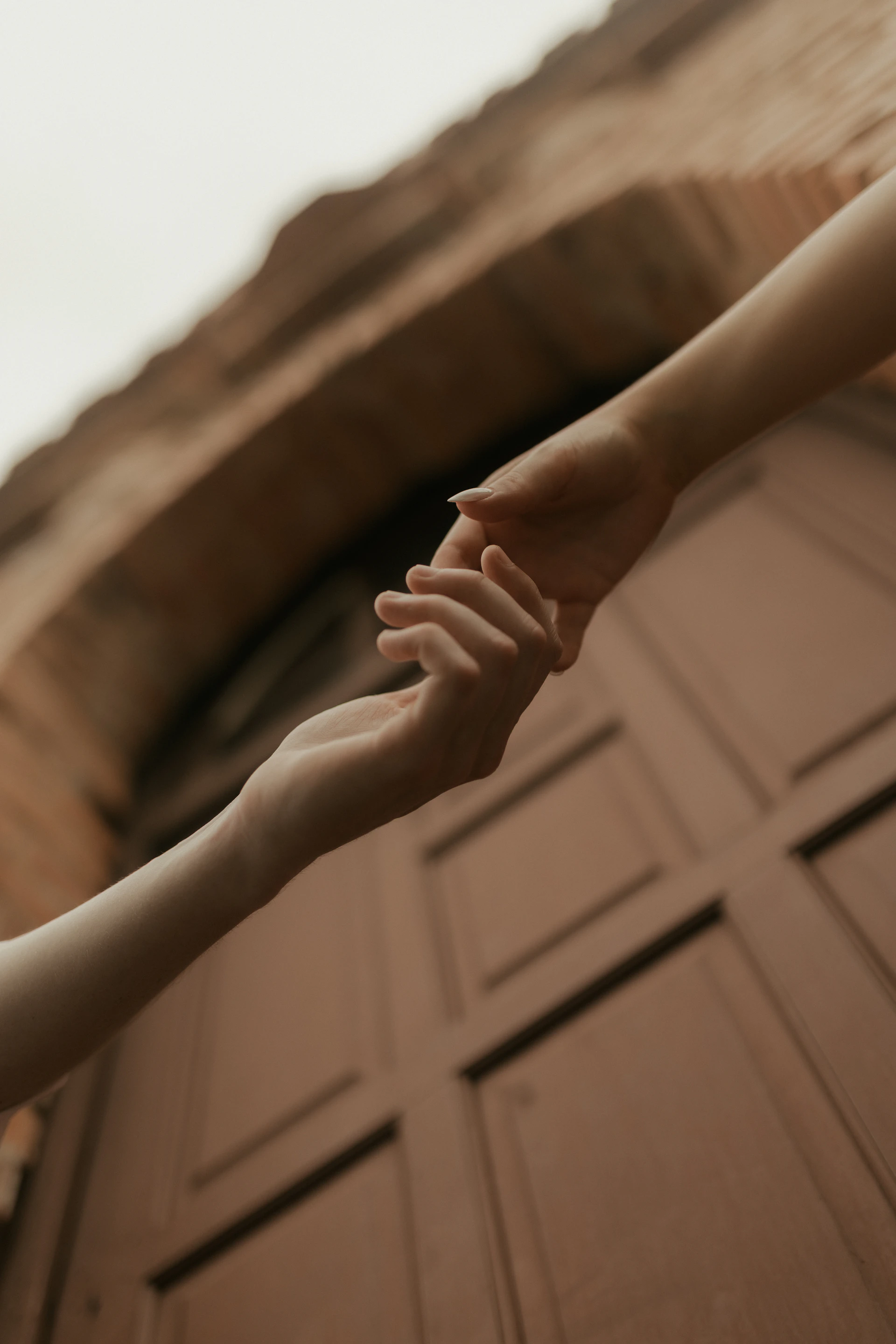 Two hands reaching for each other