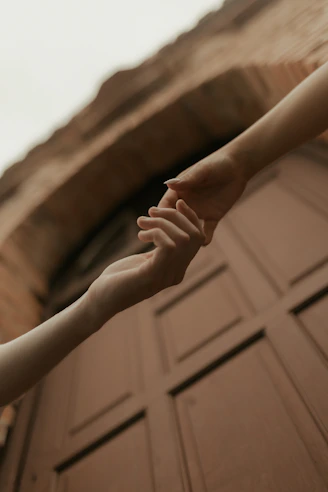 Two hands reaching for each other