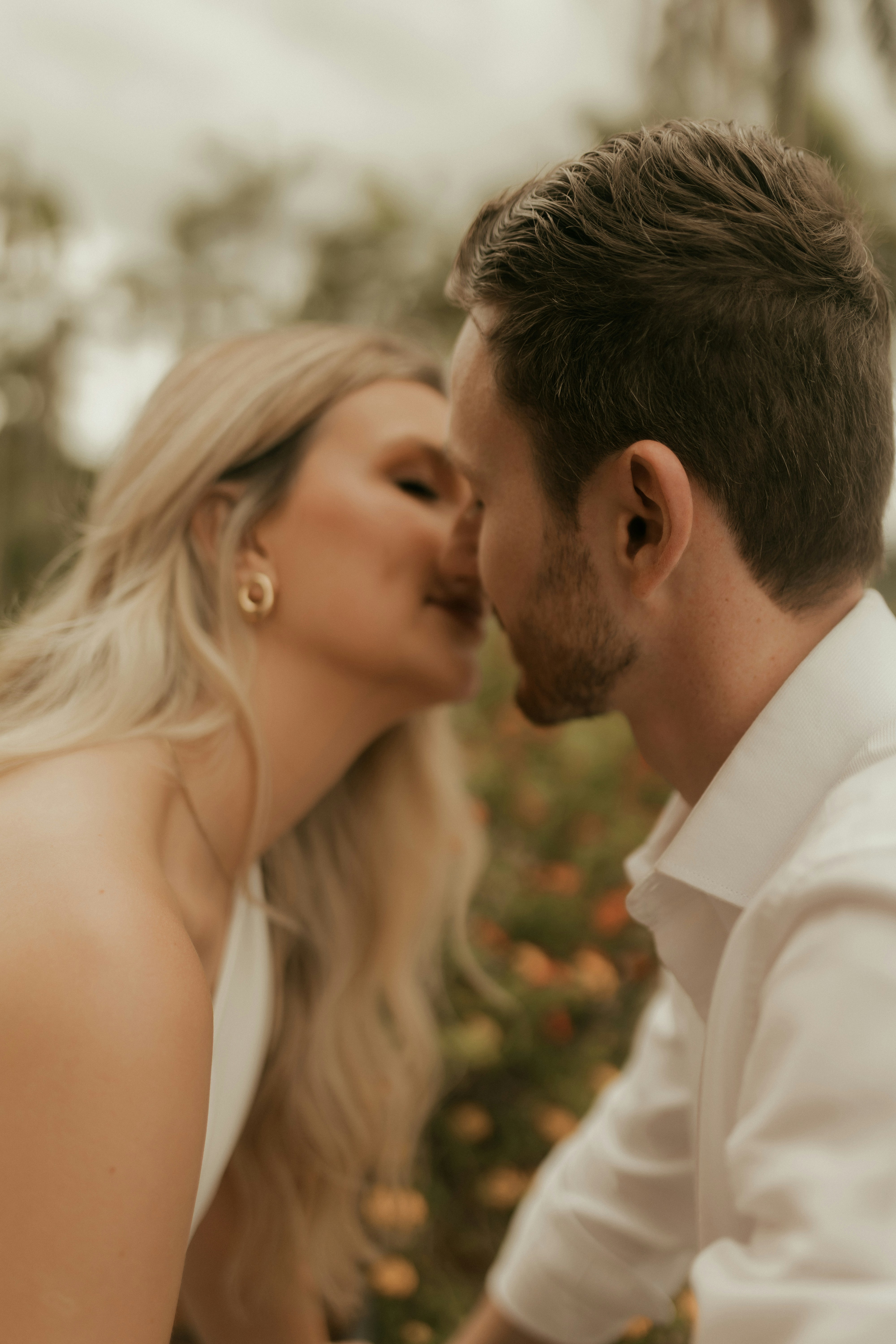 Couple sharing a tender kiss outdoors