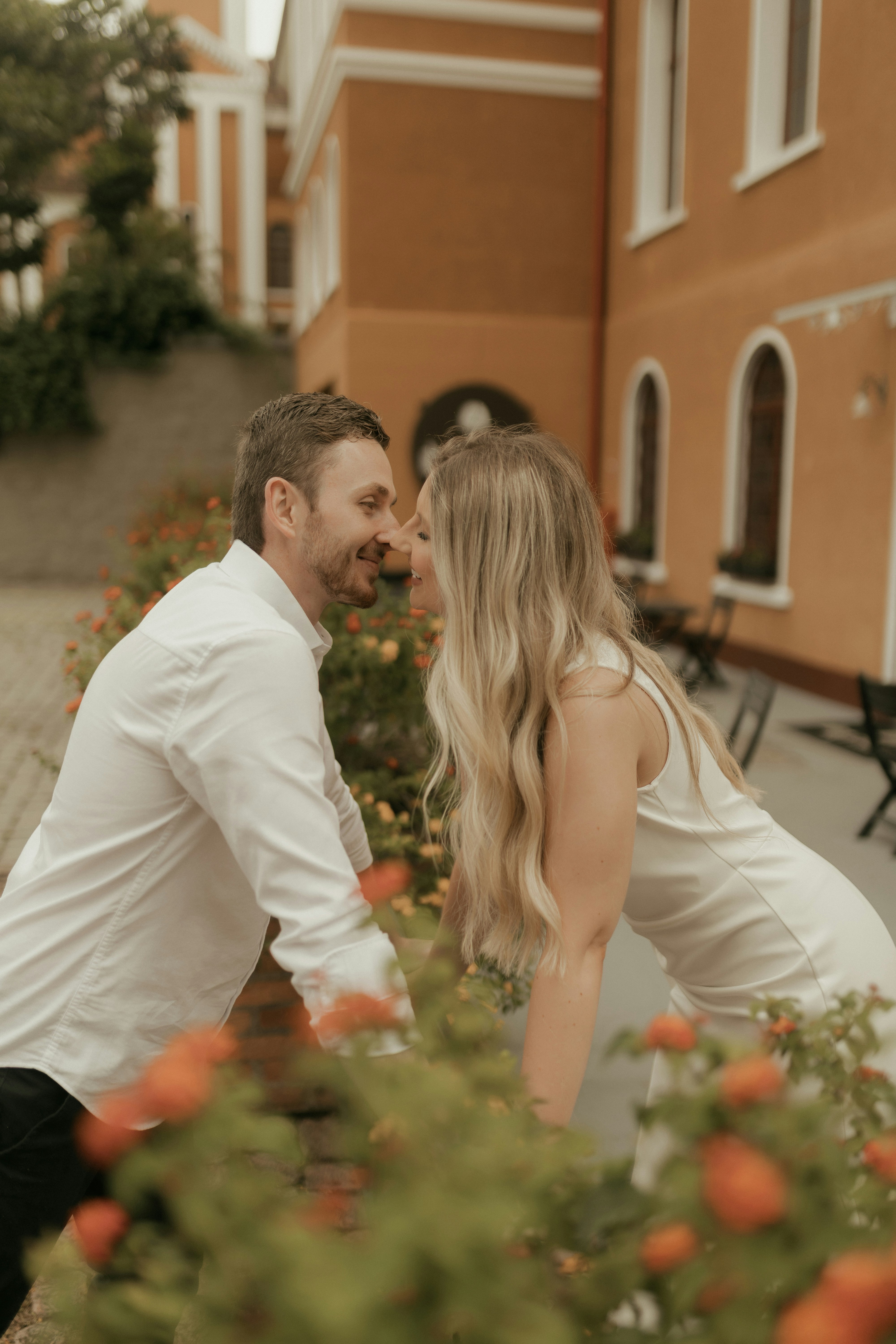 Couple embracing near colorful flowers outdoors