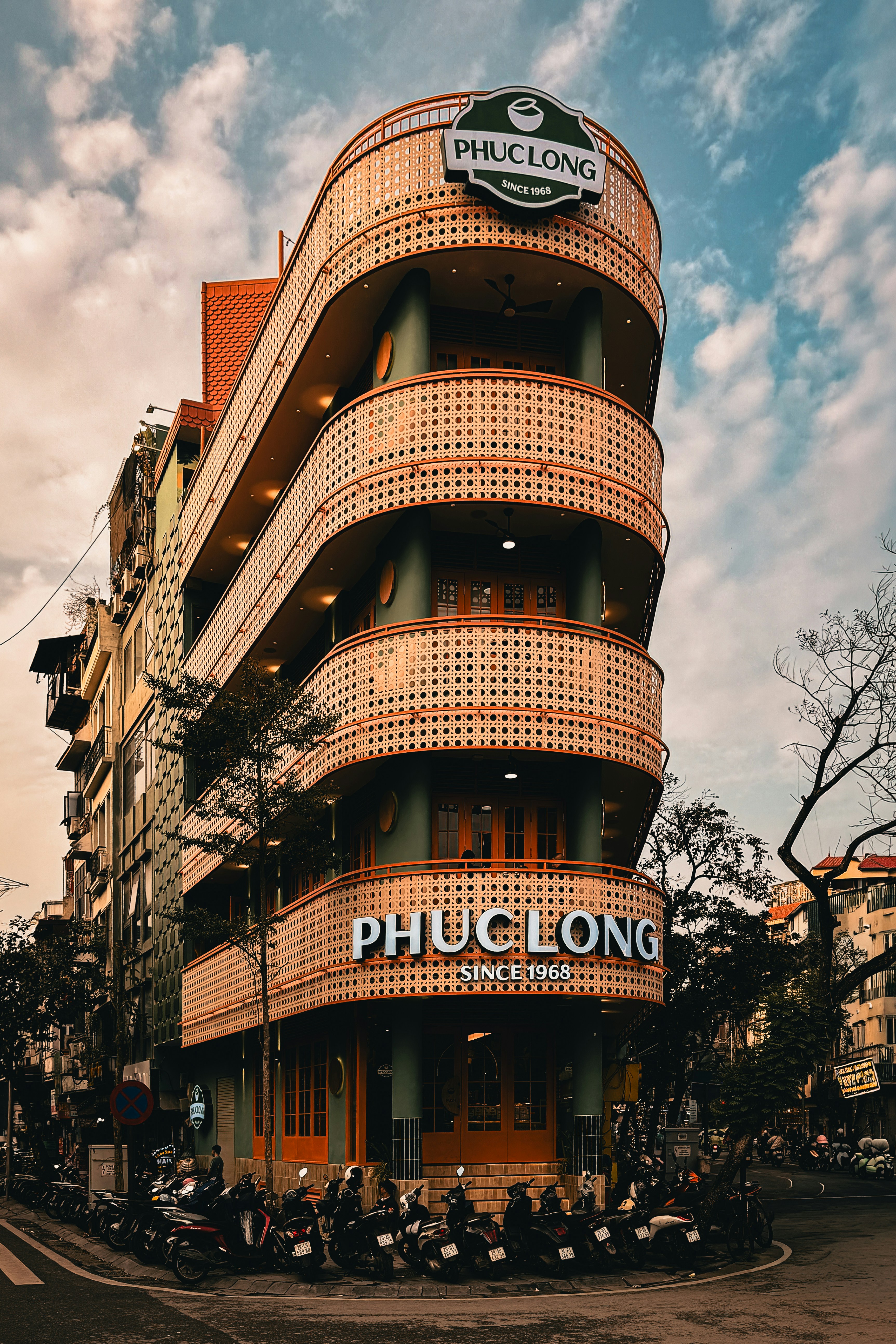 Phuc long building with motorcycles parked outside