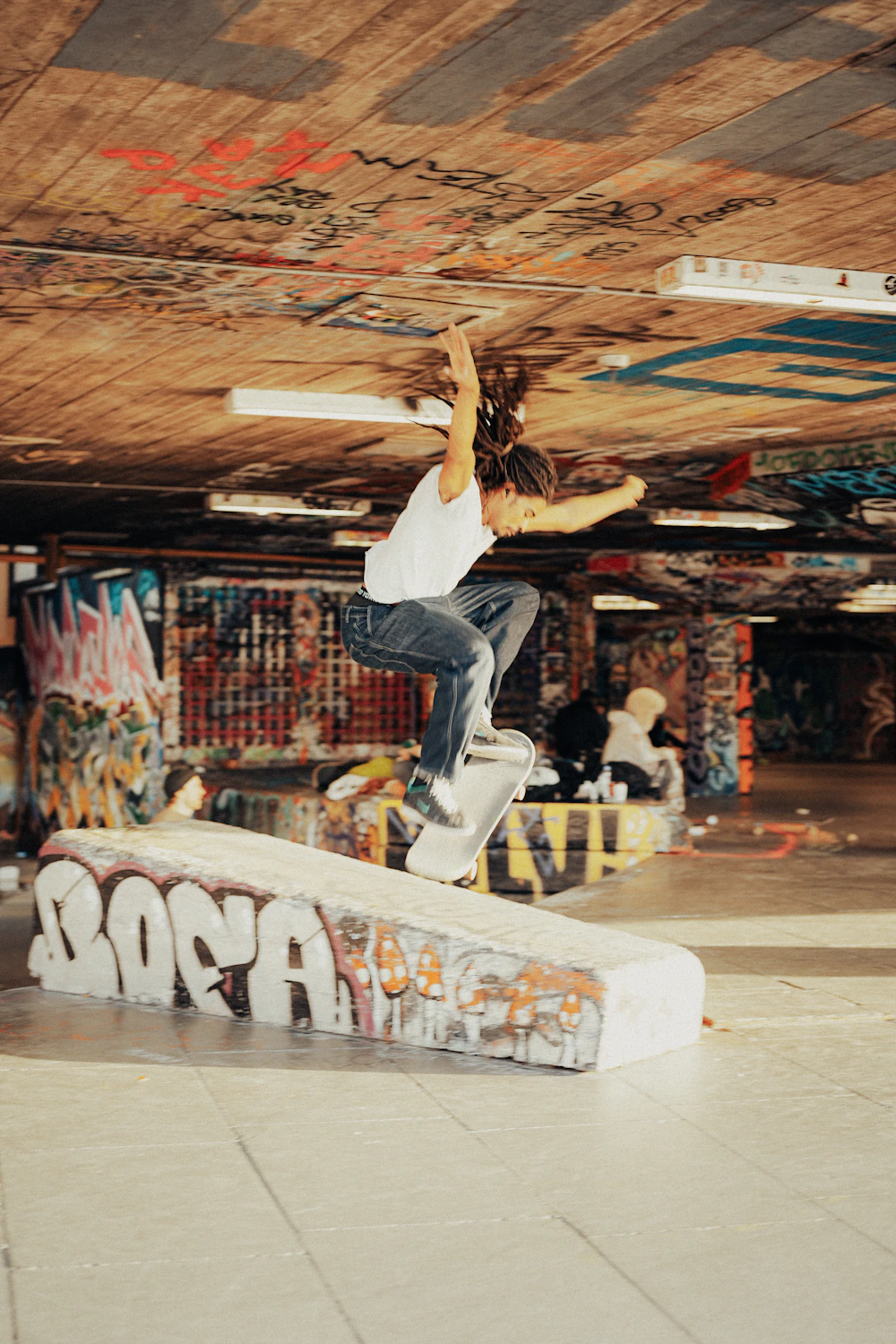 Skateboarder launching off a colorful skatepark ramp