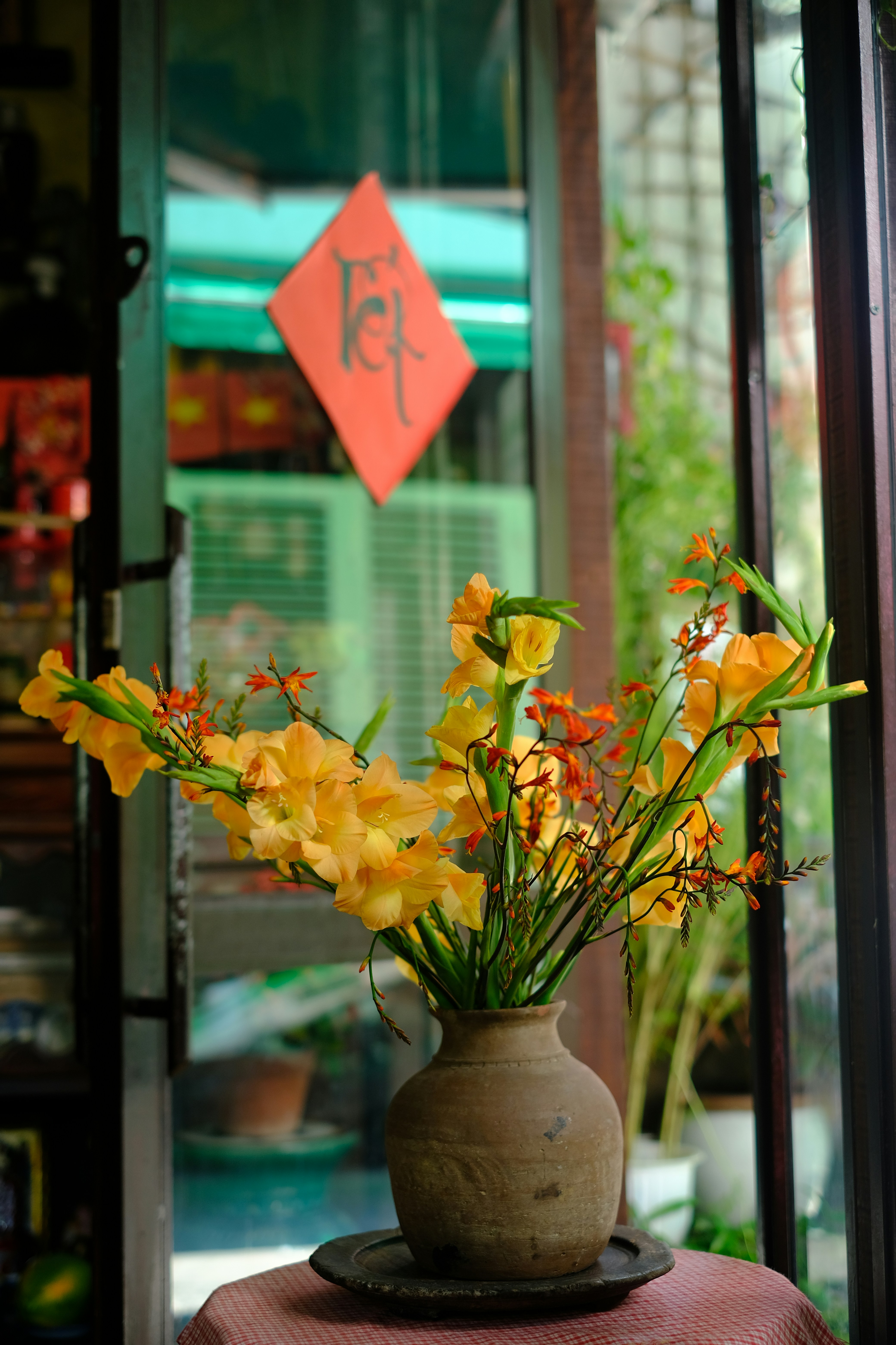 Vase of yellow flowers with tet decoration