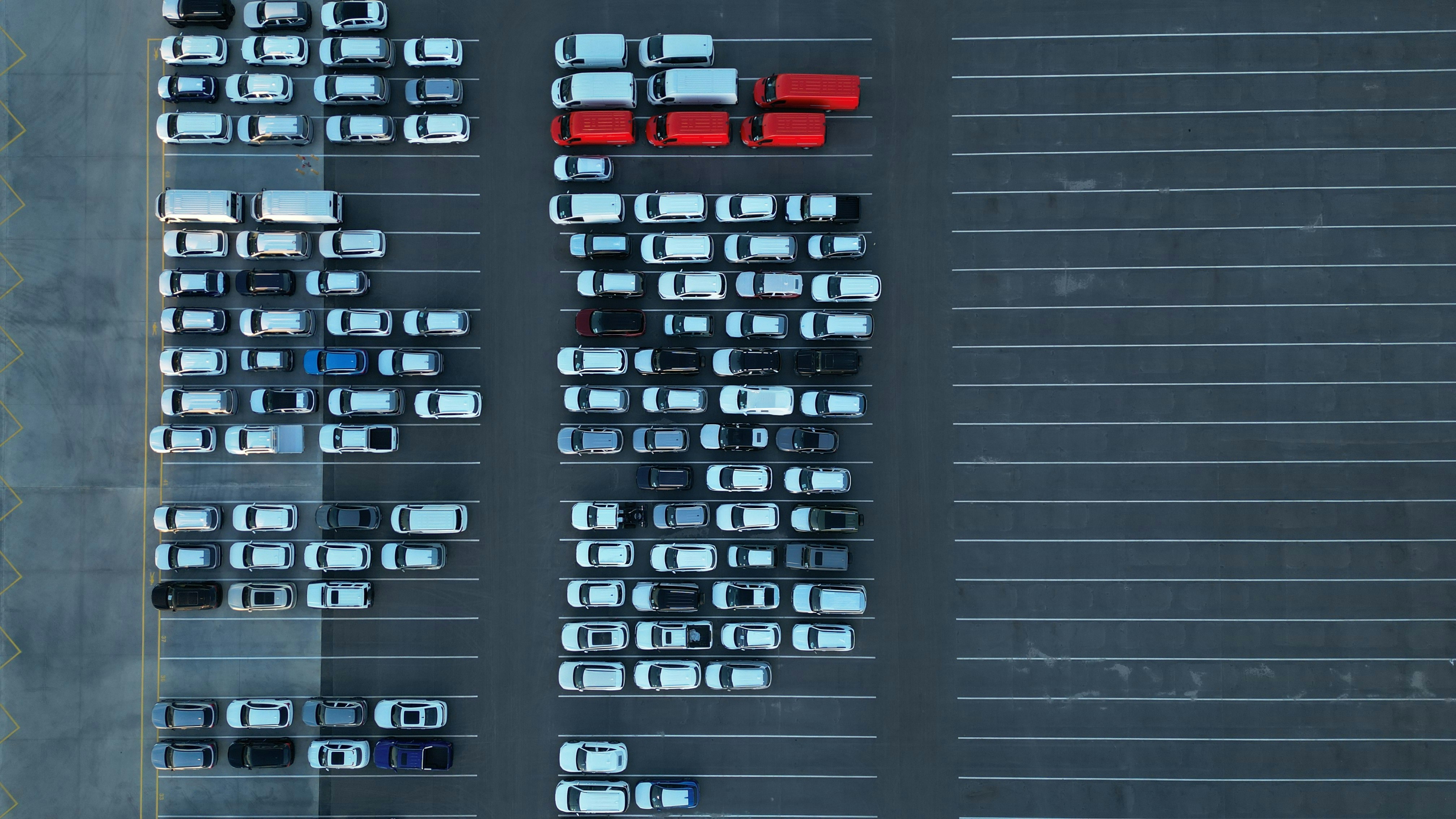 Aerial view of a parking lot filled with cars