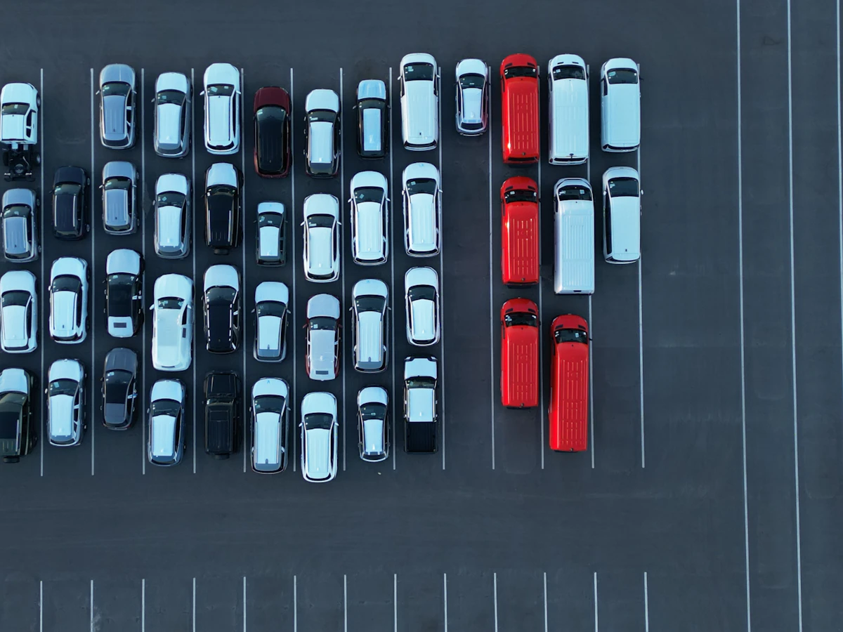 Aerial view of rows of rental cars parked in a lot