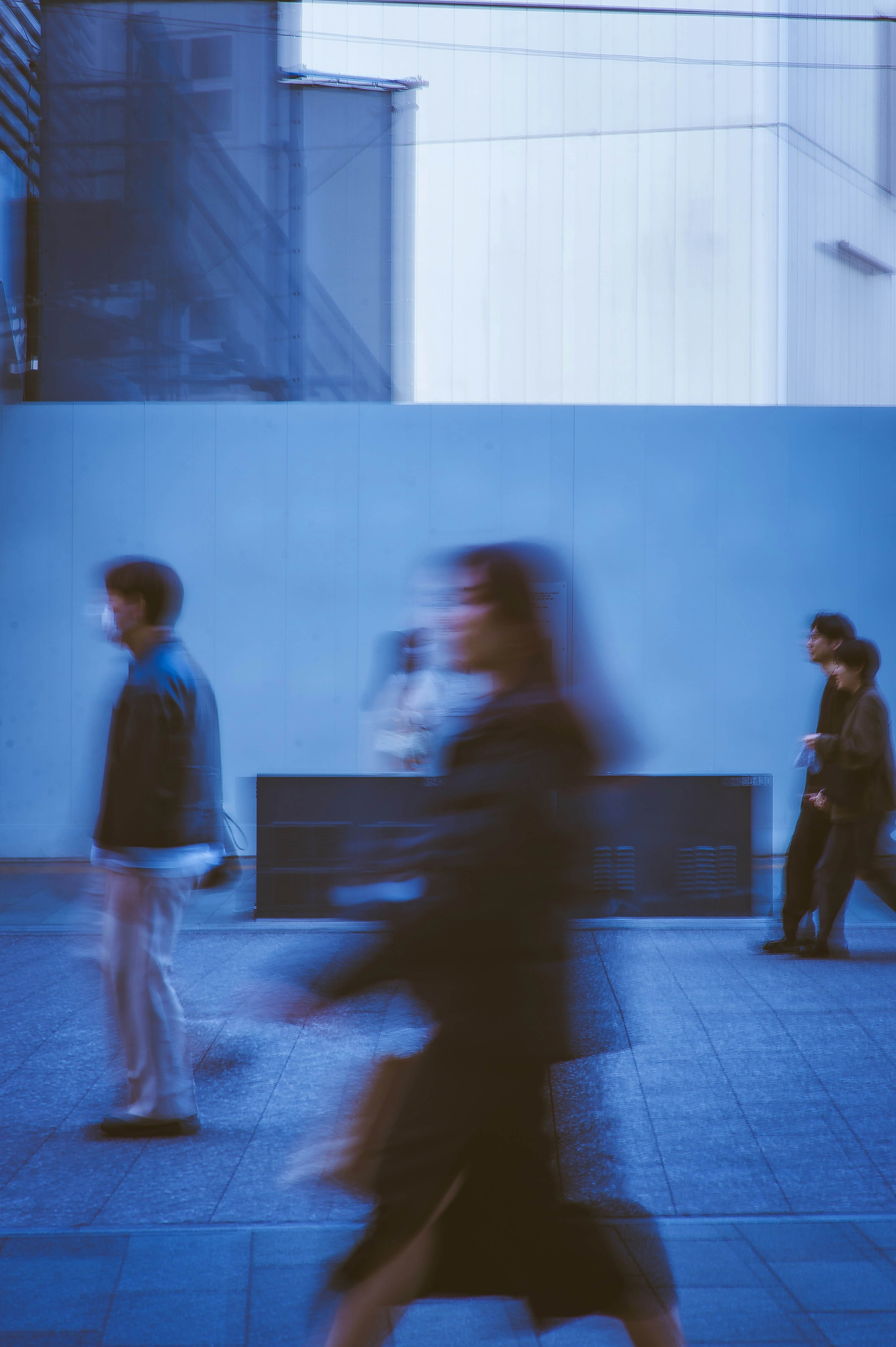 Photo of People walk on a blue tiled street. by 5010
