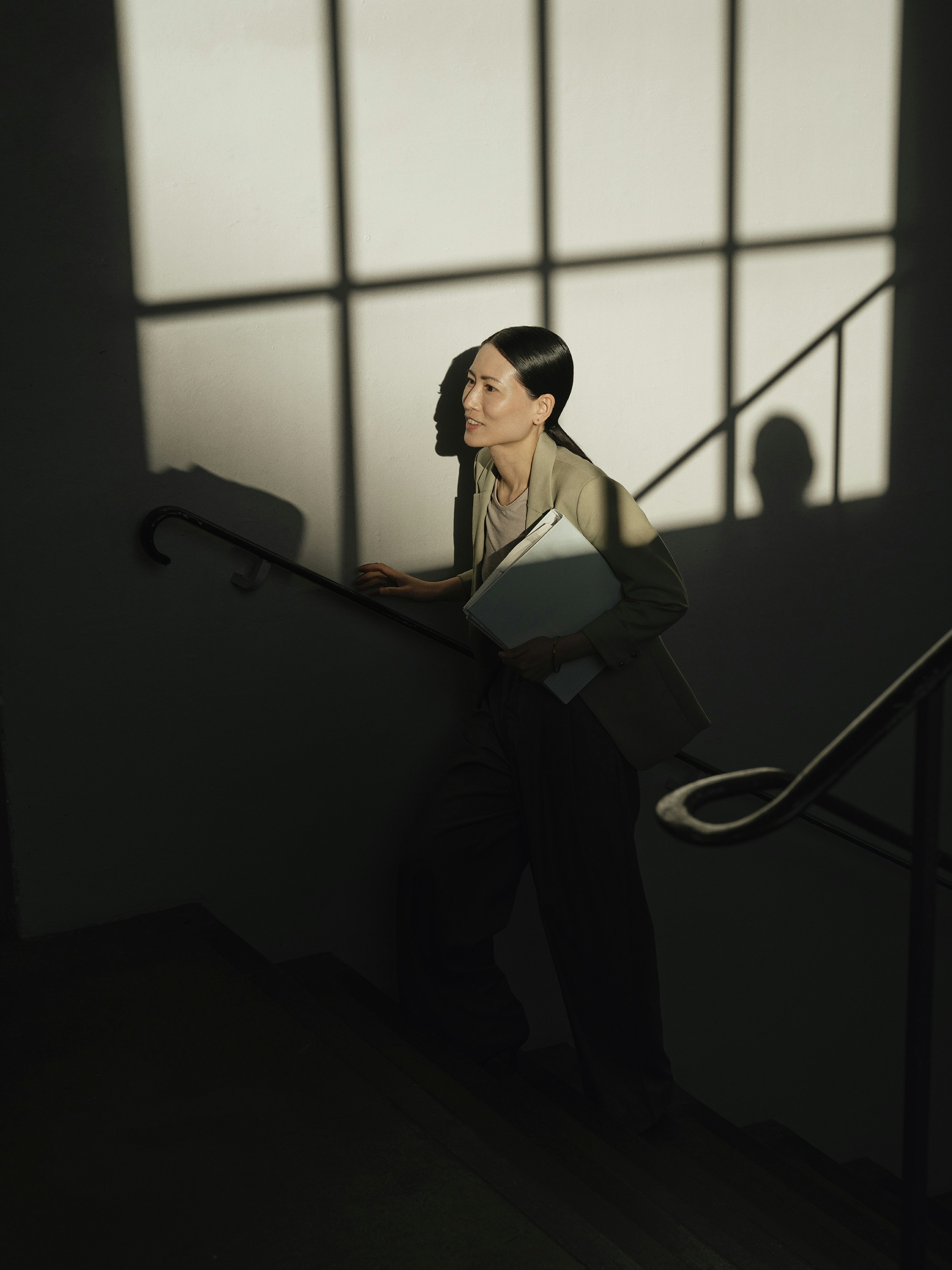 Woman walking up stairs with folder