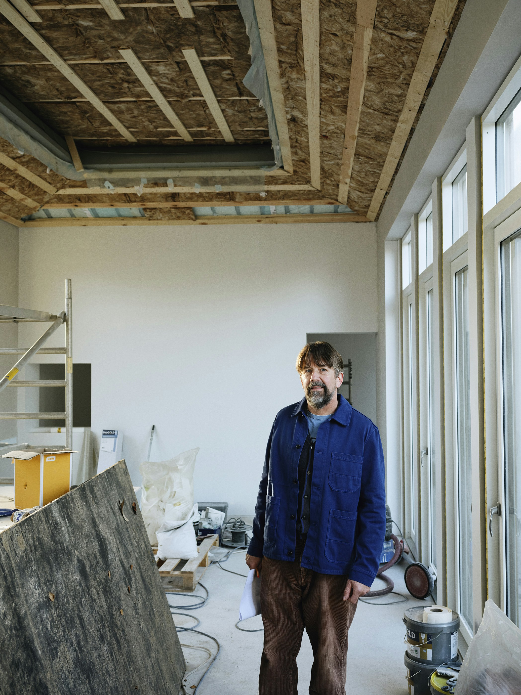 Man standing in a room under construction