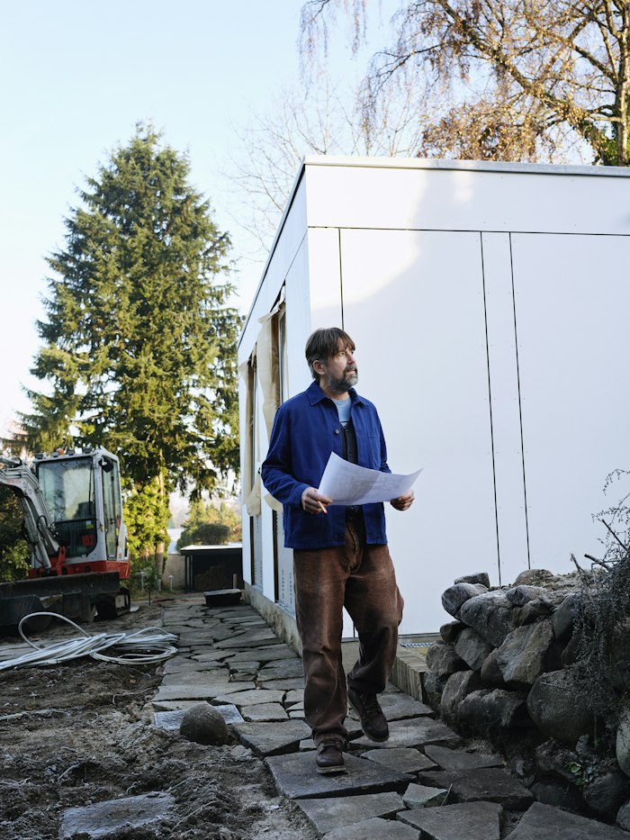 Engineer reviewing blueprints on-site before inspection